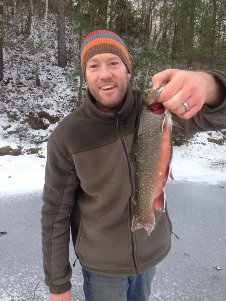 Adam with a big brookie taken through the ice.