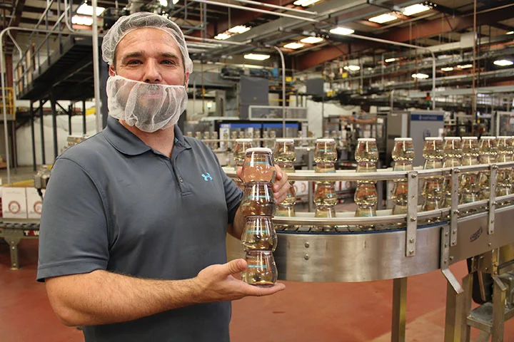 Operations Manager Jim Duty shows a four-pack of Woodbridge by Robert Mondavi wines packaged by StackTek’s facility in Modesto, CA.