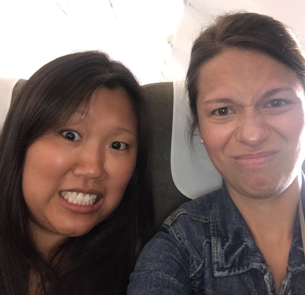 A pic Kara and Leigh Anna sent us from their flight to Saigon -- immediately after the plane's cabin had been fumigated with insecticide and the passengers behind them stuck their bare feet through the seat gap to use the armrest as a footstool 