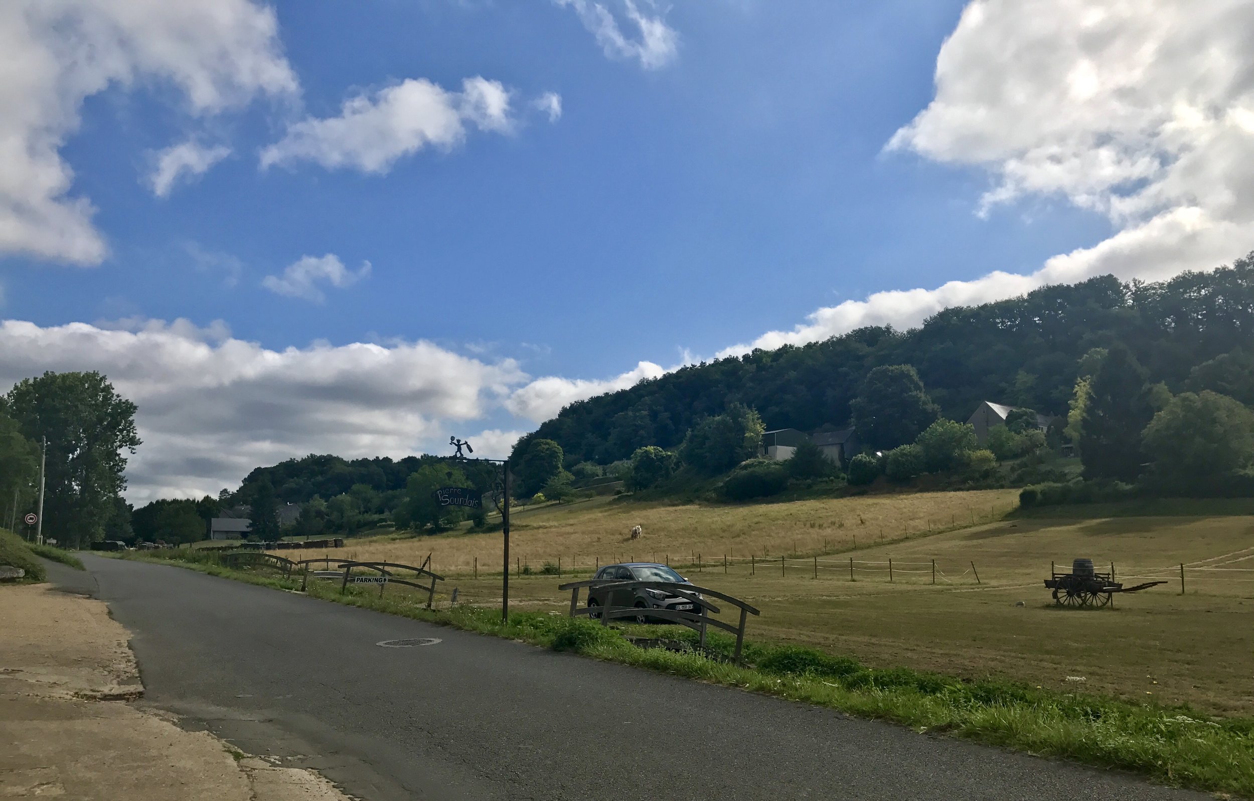 Our lonely Kia hatchback in the hay field parking lot of the first winery we visited