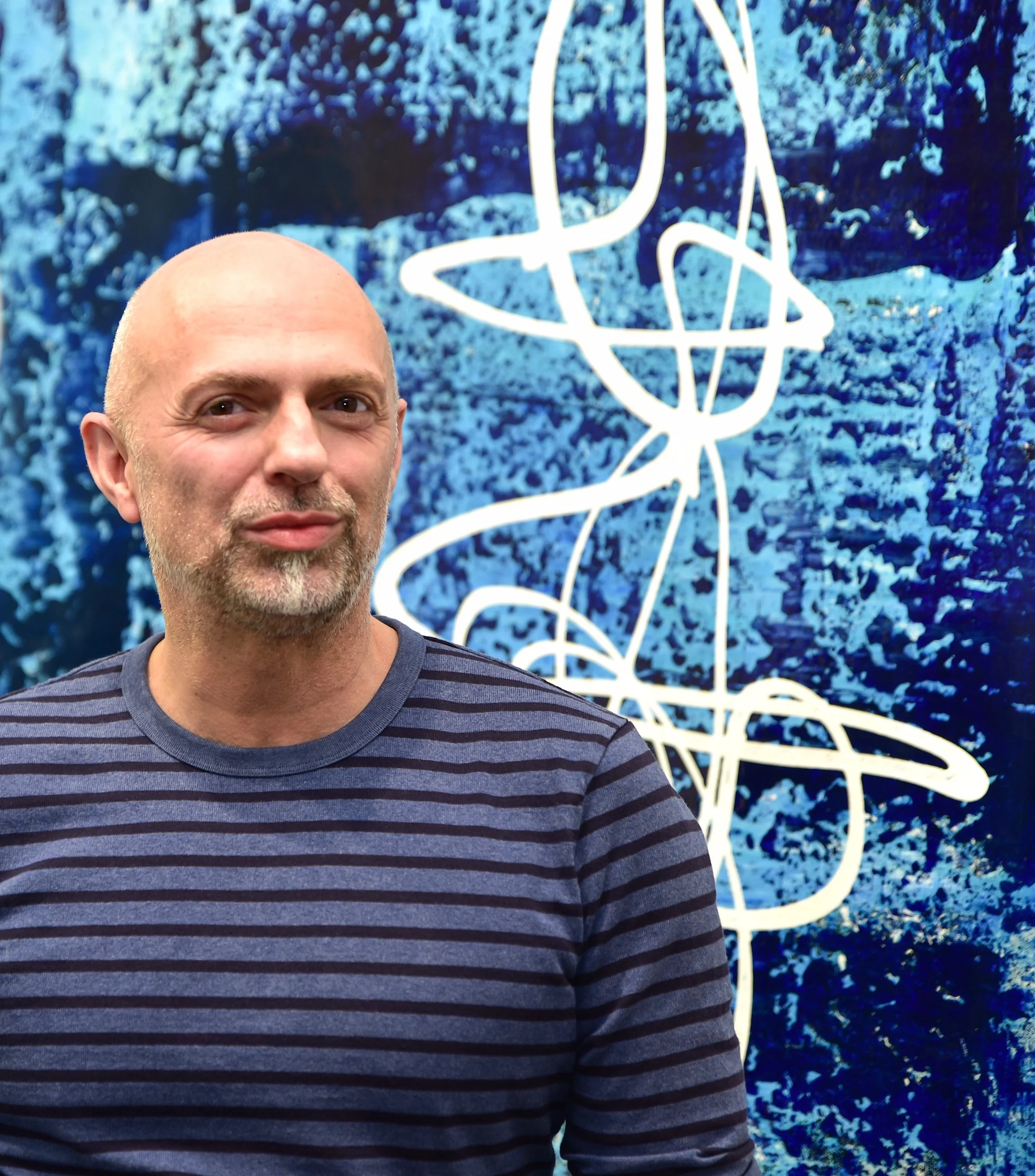 Above: Abstract Expressionist artist Thierry B., pictured in his gallery with painting, Z ensation , 2017, Synthetic Polymer Paint on Linen, 183 x 183cm, P.O.A
