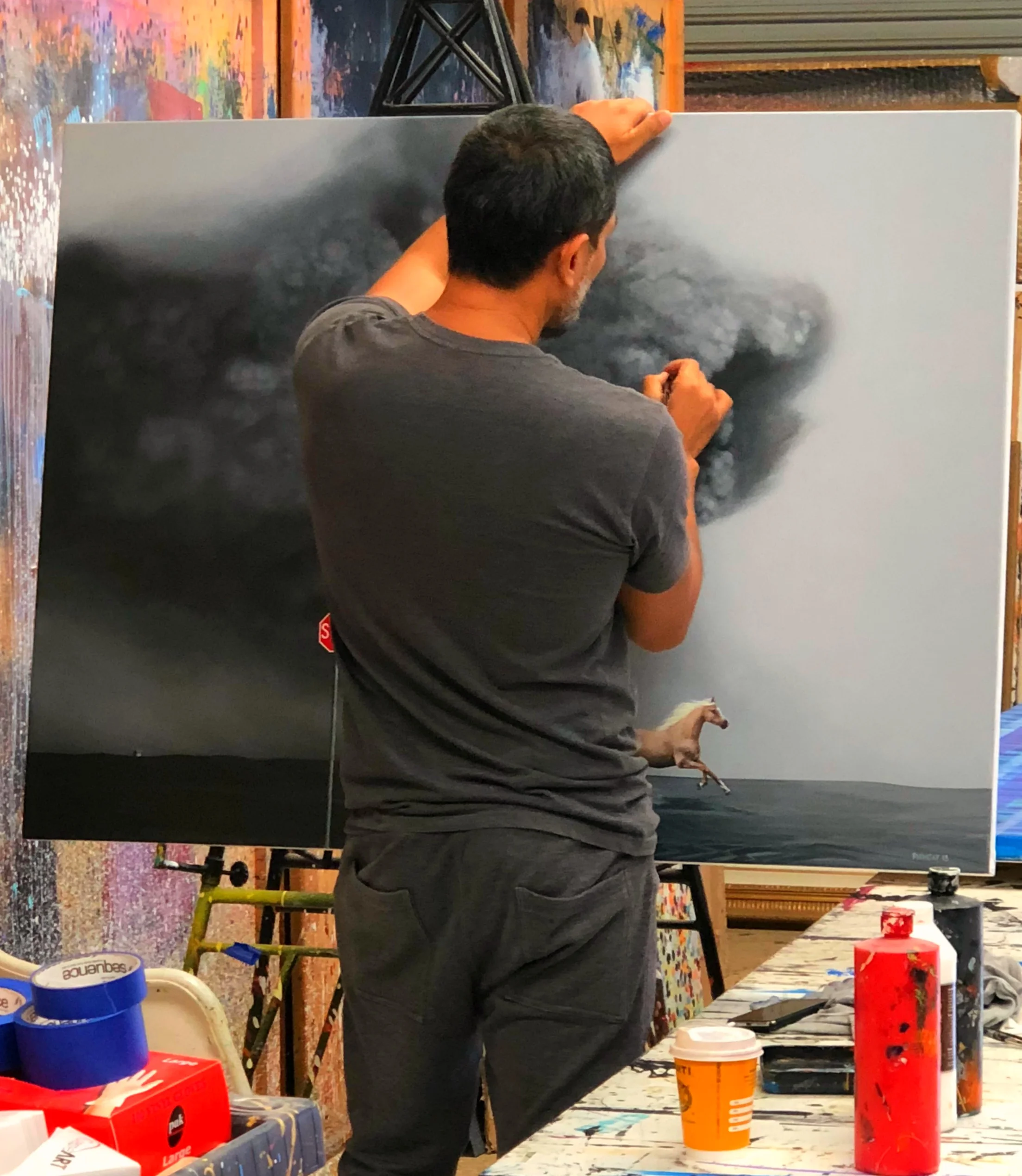 Above: Hyper-realism artist, Phonsay painting in his Albury-based studio.