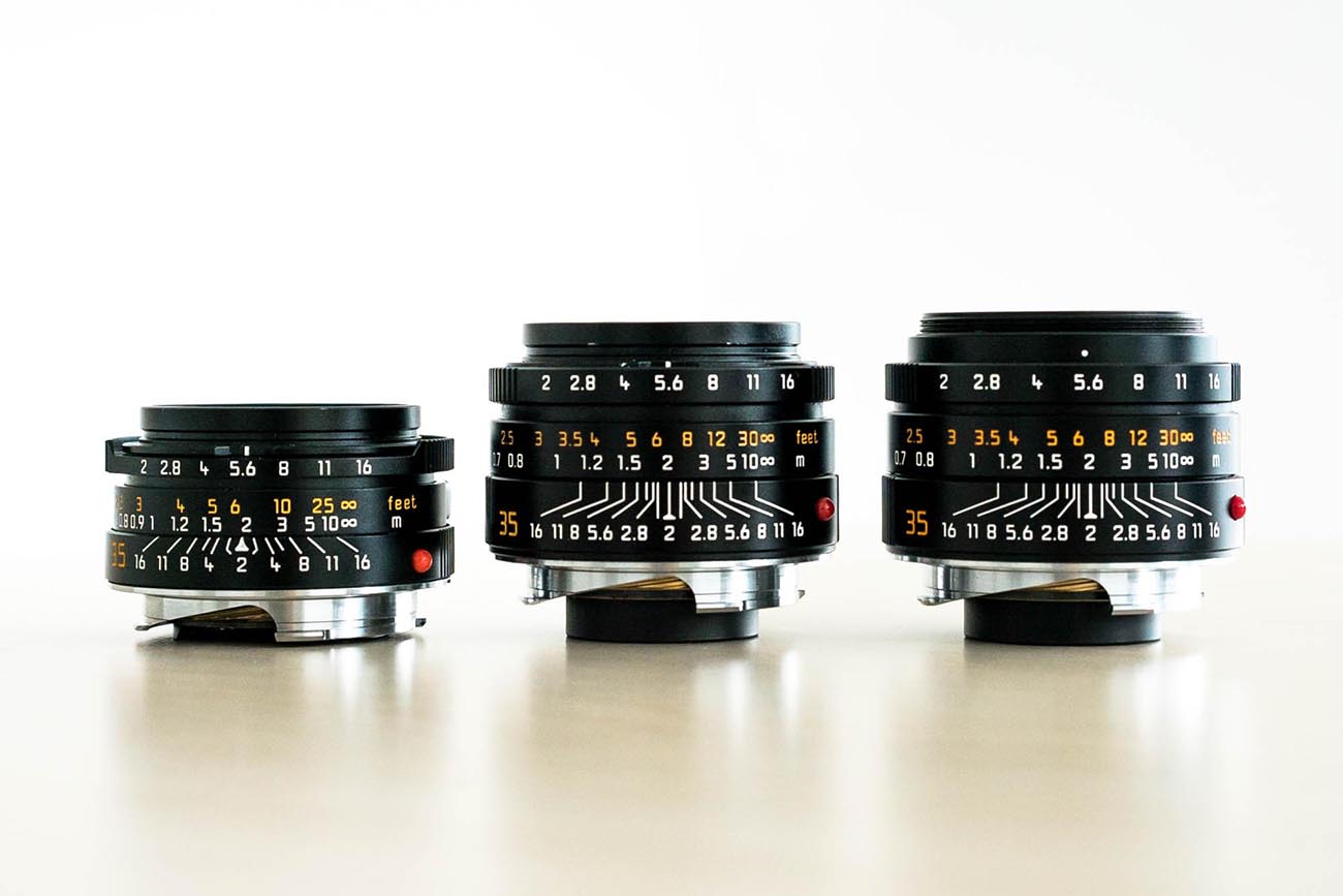 Three generations of 35mm Summicrons. From Left to Right - pre-aspherical 35mm Summicron version IV "King of Bokeh", 35mm Summicron ASPH (previous version), and 35mm Summicron ASPH version 2 (current version). Also notice the white scuff marks on the previous version Summicron (in the middle). That's where the paint was scratched off by the clips of the rubber hood.