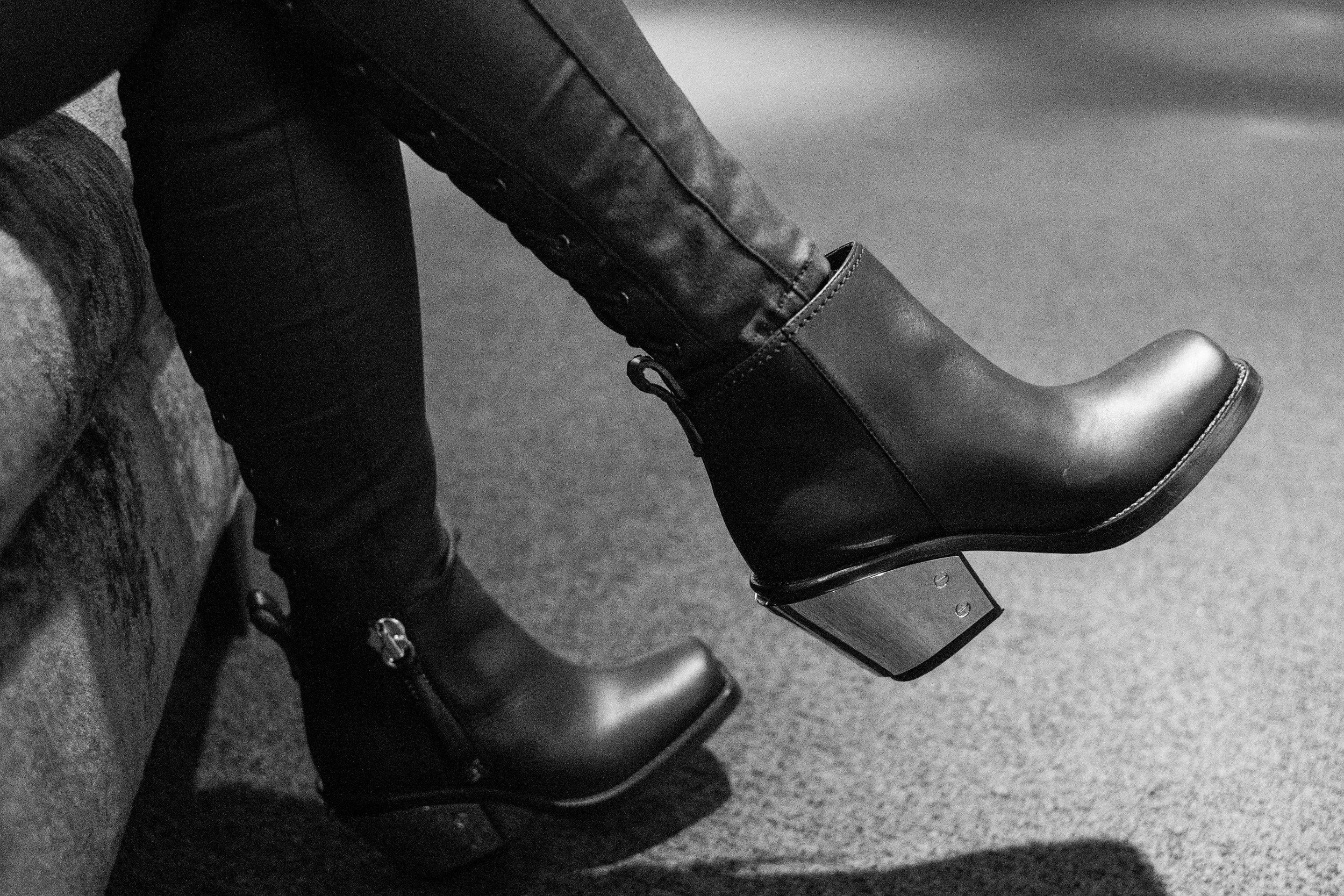 This must be art. It's a deliberate close up of someone's designer ankle boots.