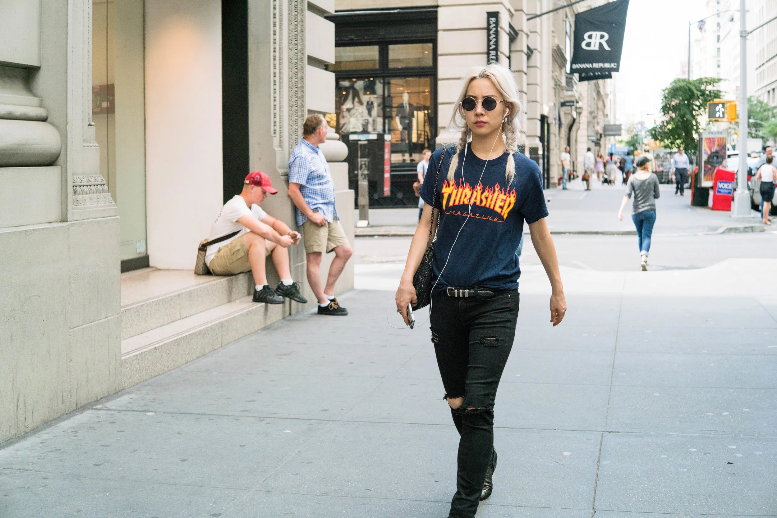 Full crop, shot at f/4. At this aperture, the corners don't look particularly sharp. This subject caught my attention, because of her platinum blonde braided pigtails and Thrasher T-shirt.