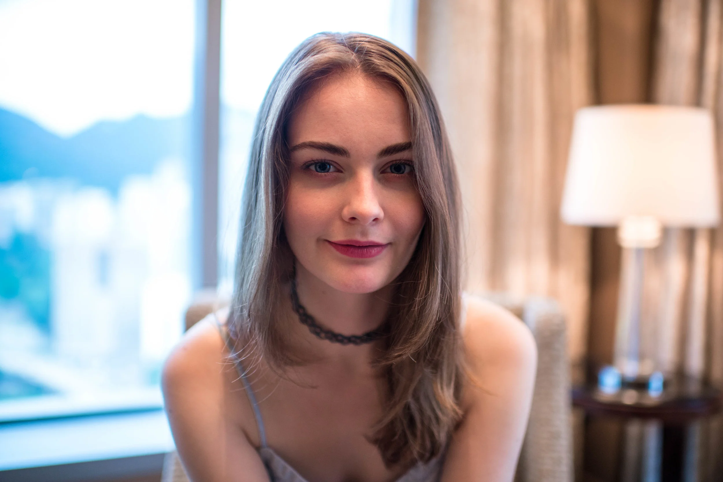 D800E + 35mm f/1.4G. Not quite up to her face, but I think I was less than four feet away. Still there was noticeable distortion.