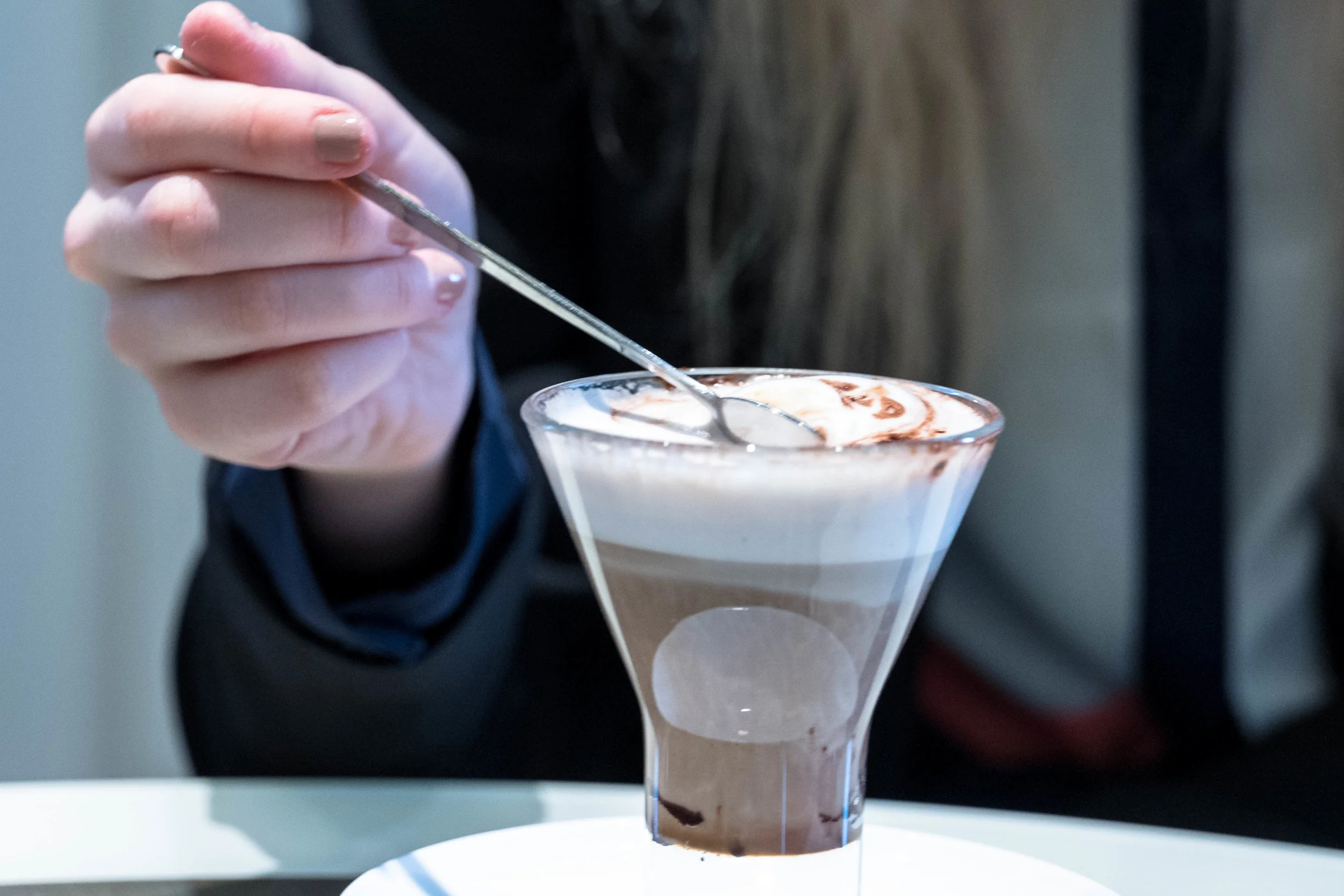 A cropped closeup of her café latte.