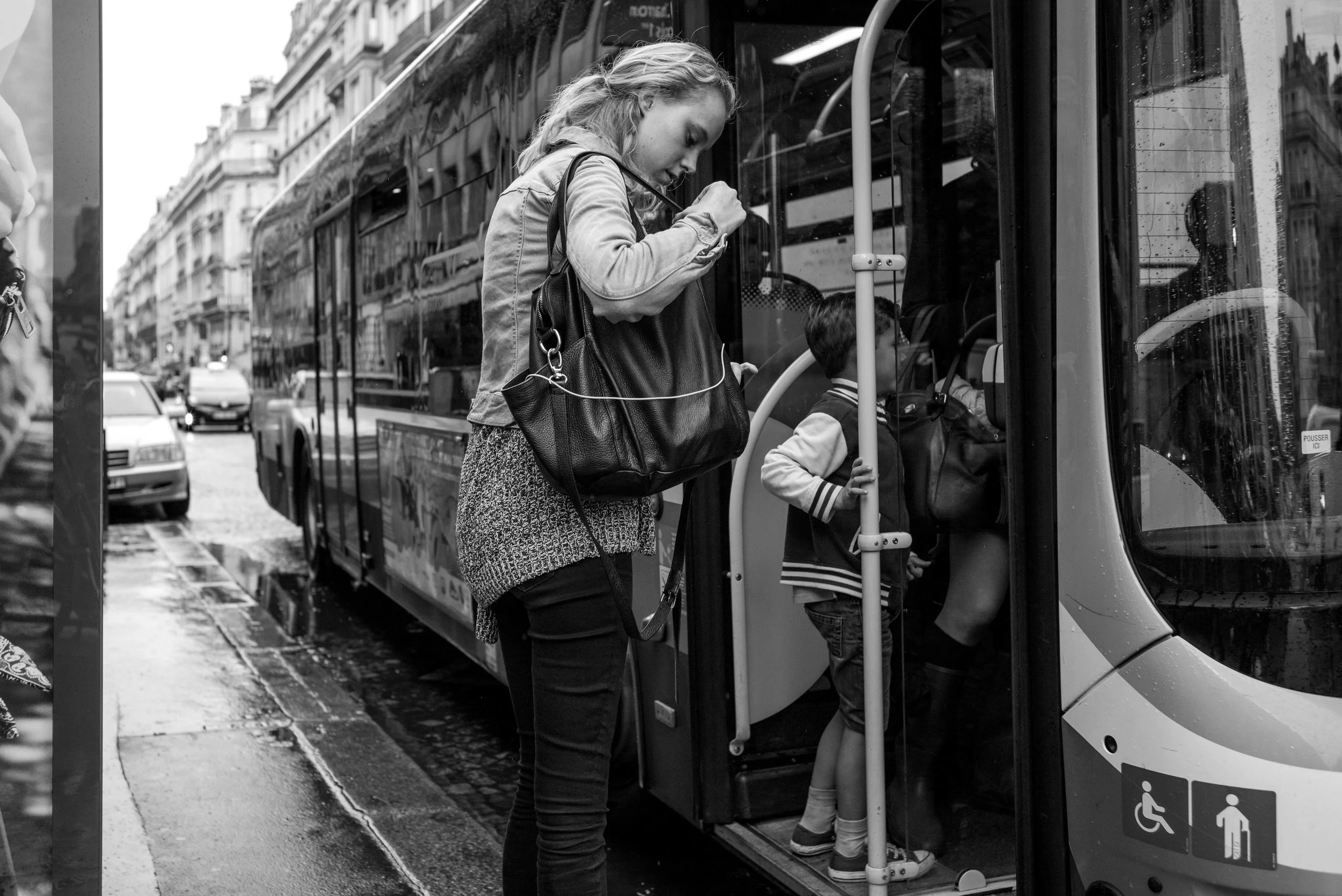 A woman getting onto a bus. Not exactly interesting. But since I was just standing around the bus stop, it was an easy photo opportunity. So I figure why not. Not exactly much thought was put into it.