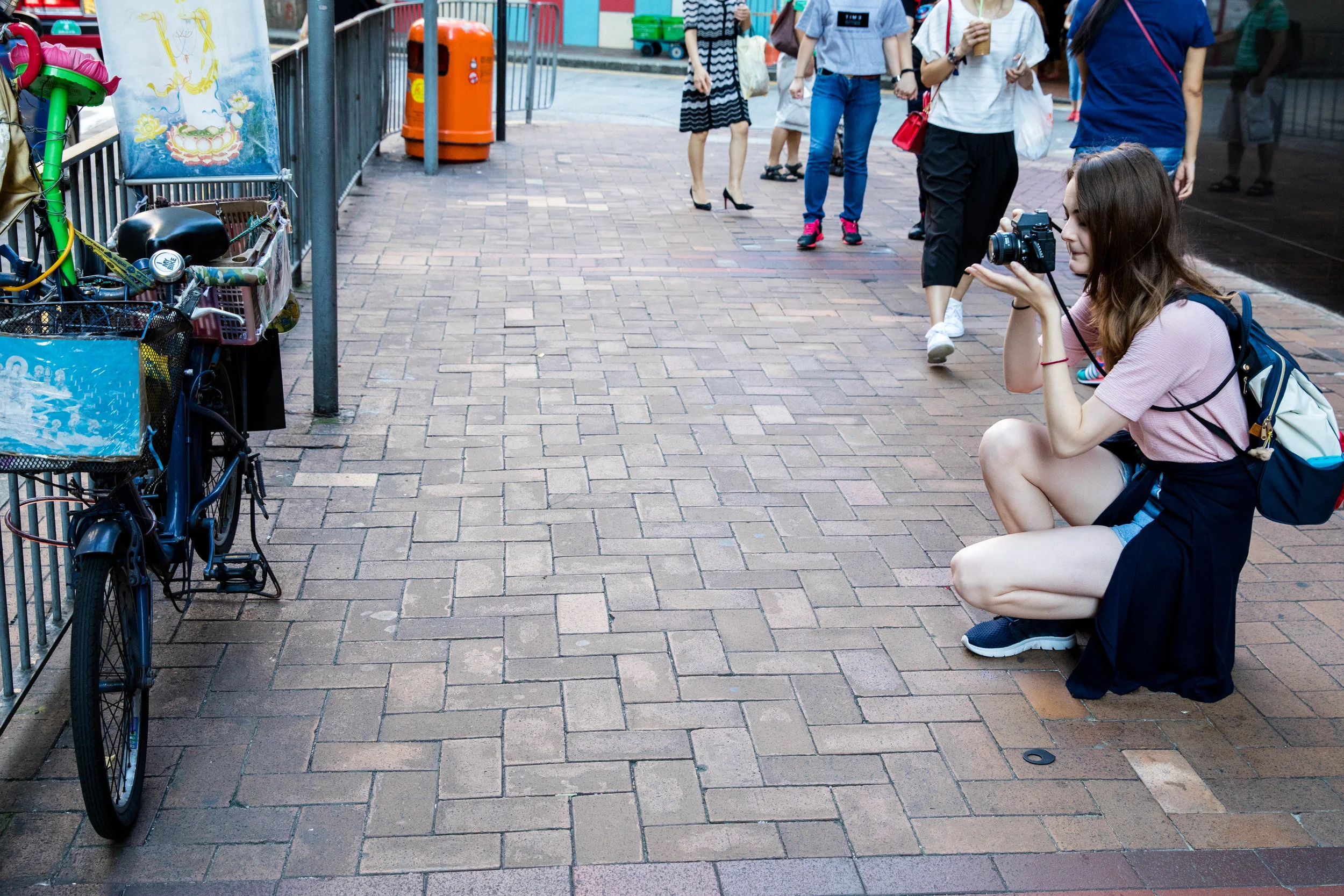 Kneeling down for a better perspective. Documenting a bicycle for her own interest.