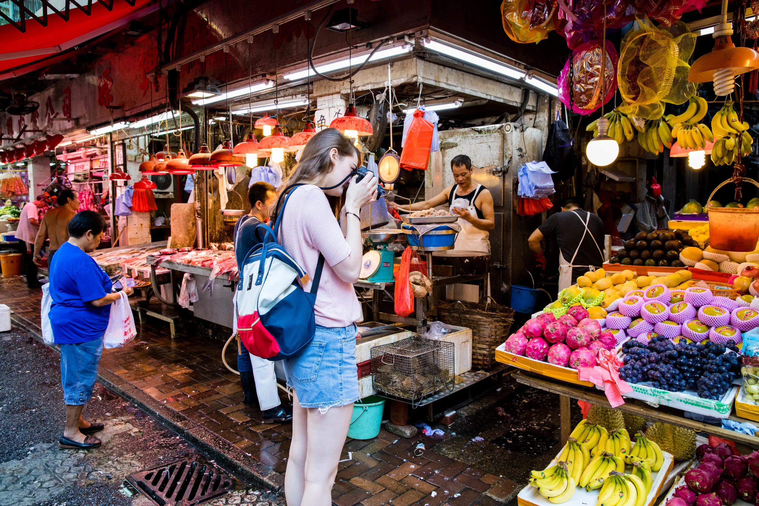 Photographing fruits at an open air market. Something I would never do.