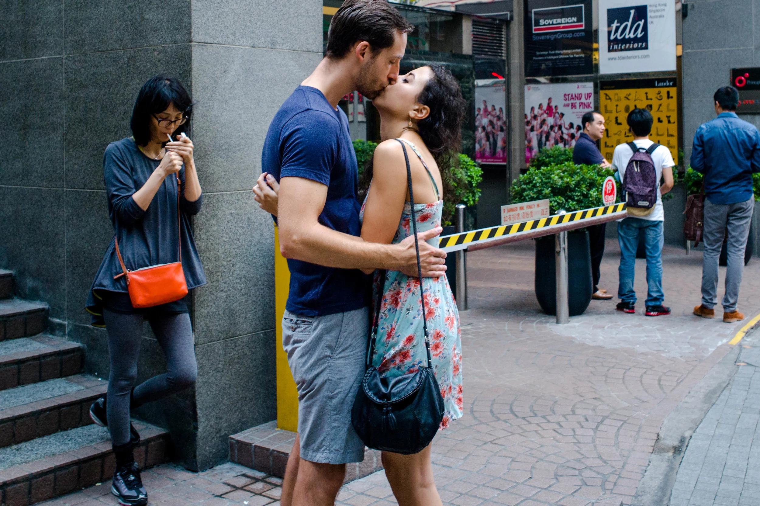 You would think that documenting a kiss is purposeful. But is it? Besides, the composition of the image is compromised with the lady smoking in the background. That smoker is competing for attention. If I had shifted my position, perhaps I would have gotten a better picture. Then again what would be the purpose, other than that kiss?