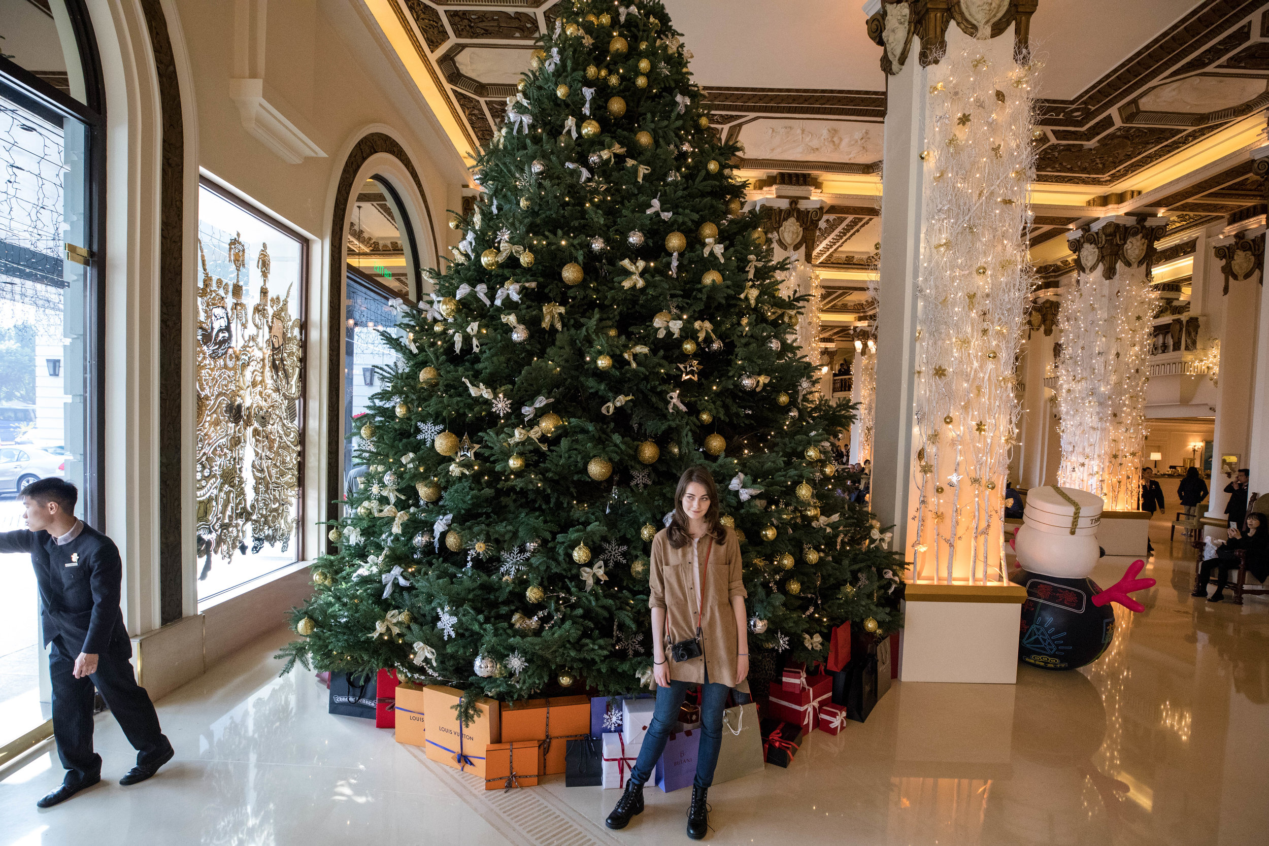 Back down at the Peninsula Hotel lobby waiting for our Über. To minimize unwanted foreground content, I shot this with my camera held over my head, with live view, and autofocus locked on to Anna's face. Canon 16-35mm f/2.8L II. Shot at 16mm. Cropped slightly to edit out an unwanted foot coming through the opening door.