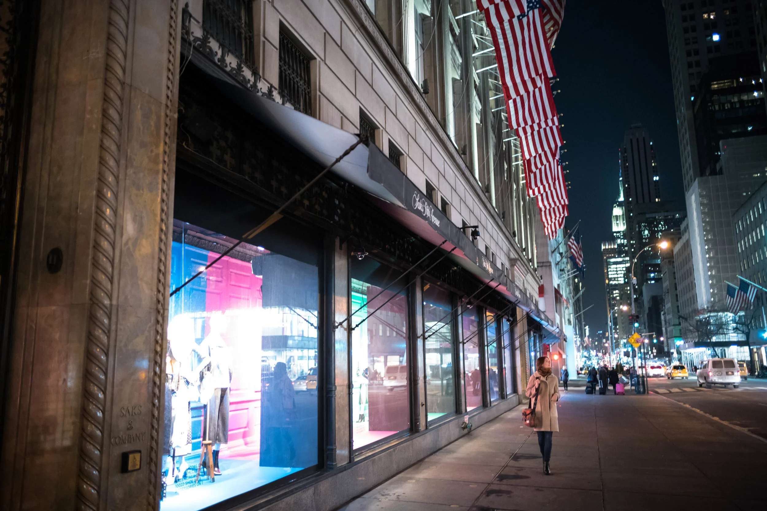 Walking up Fifth Avenue with all the flags outside Saks Fifth Avenue.