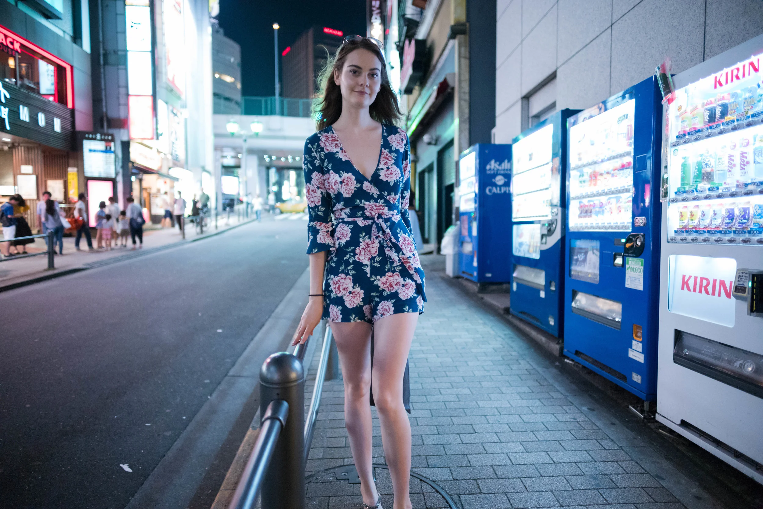 Inside a side street by a Japanese vending machine.