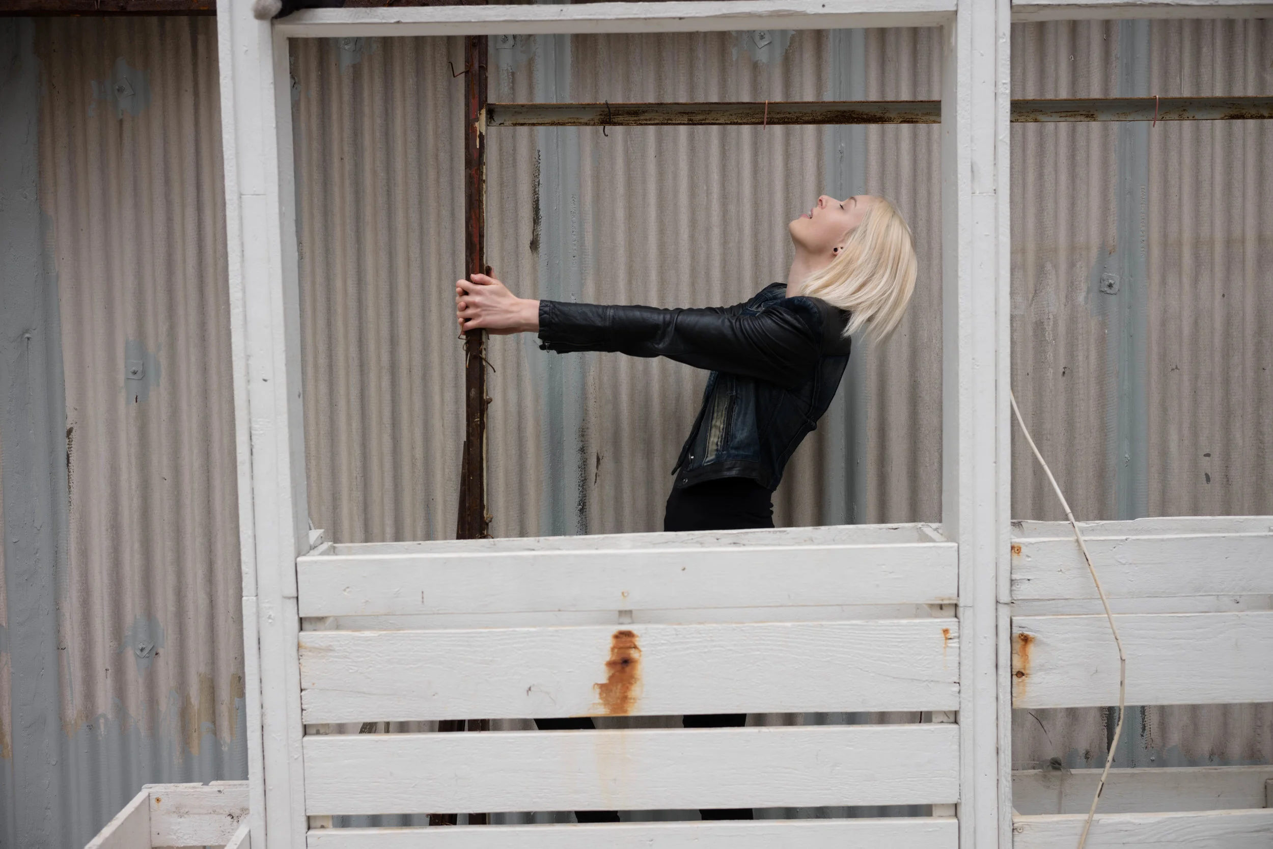 Hanging on to a rusty pole.