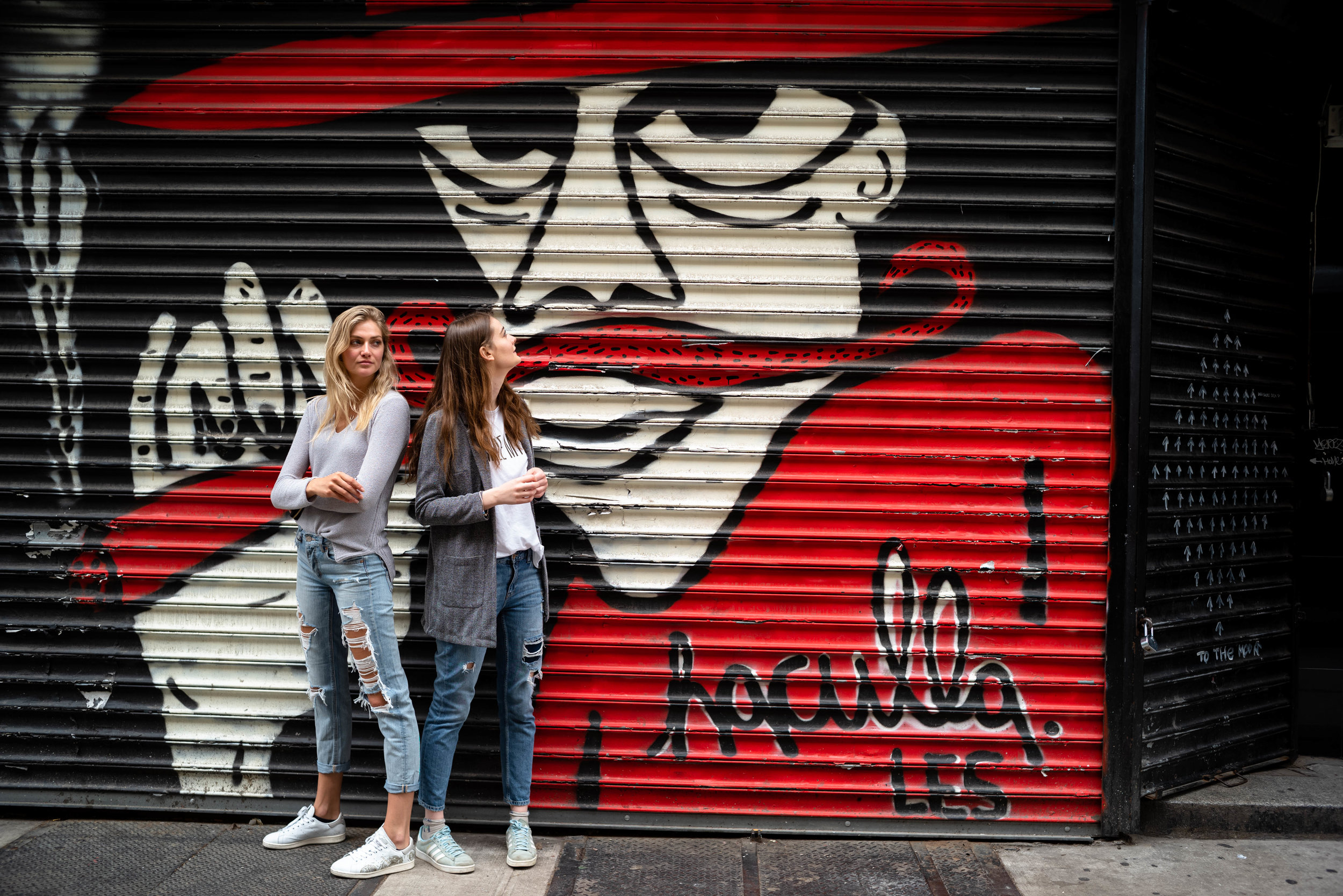 In front of graffiti, in the Lower East Side.