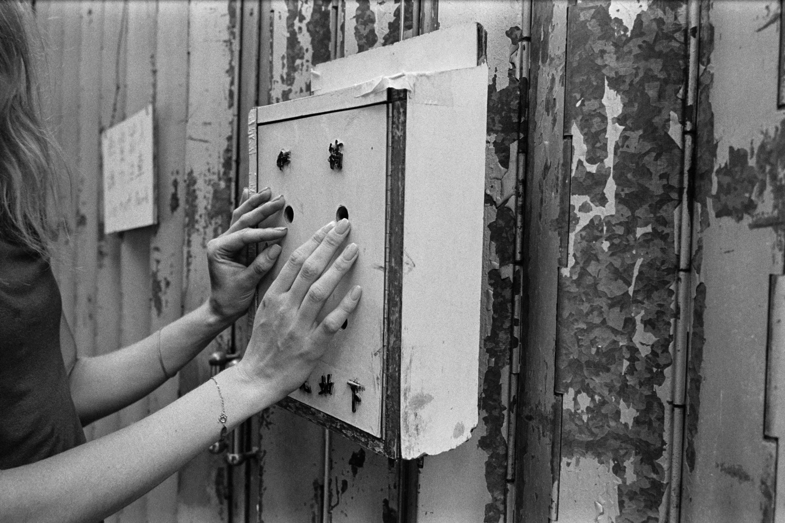 Kodak Tri-X 400 @ 28mm Focal Length - Interacting with the environment by snooping inside a mailbox. Compositional variables include peeling paint, and the mailbox.