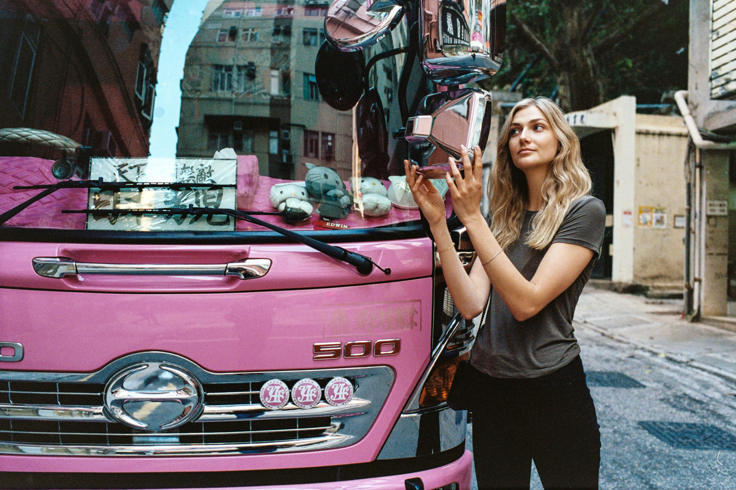 Kodak Portra 400 @ 35mm Focal Length - Interacting with the environment by looking into a truck’s sideview mirrors. Compositional variables include pink truck and its contents.