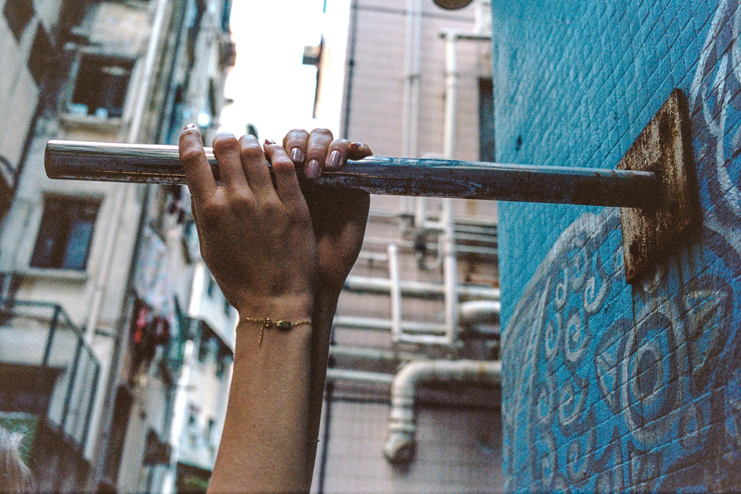 Kodak Portra 400 @ 35mm Focal Length - Interacting with the environment by hanging onto a protruding pole.