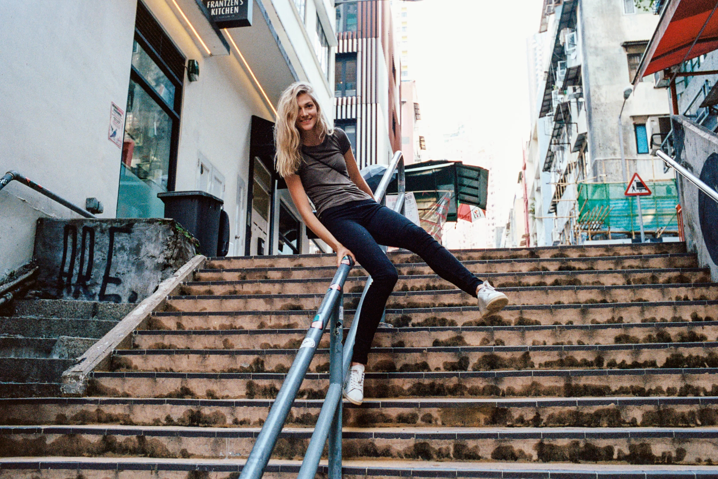 Kodak Portra 400 @ 35mm Focal Length - Interacting with the environment by sliding down a bannister. Compositional variables include stairs with discoloration.