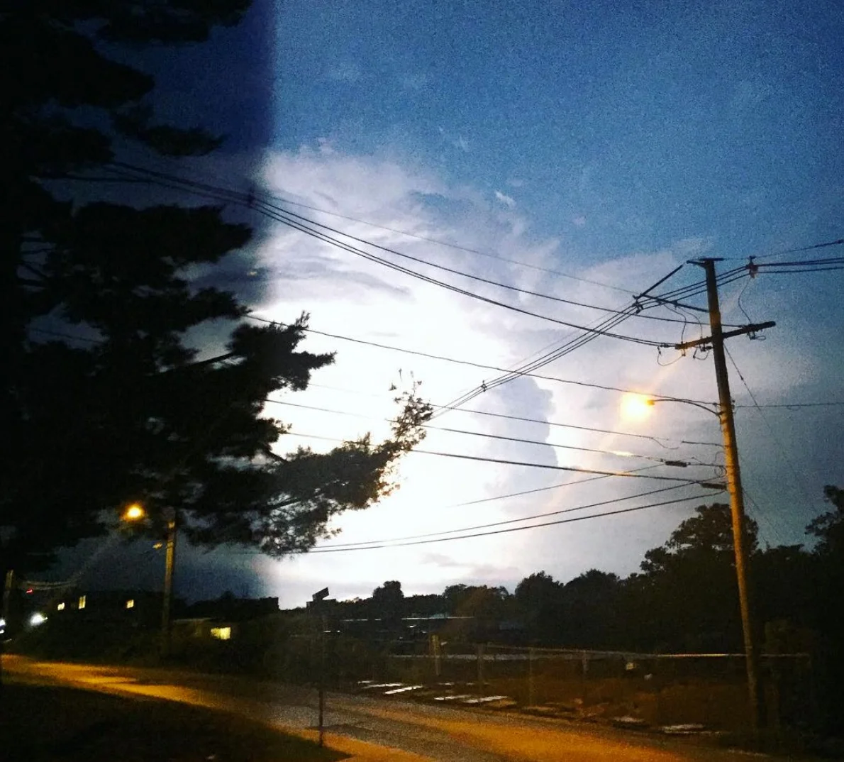 Lightning striking and brightening the sky with white. Photo Credit: Marjorie Tarter @majolie126