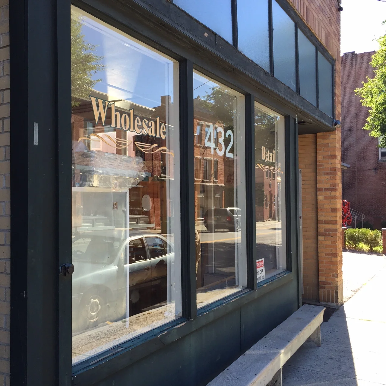 The storefront window of 432 Main Street, home of Hudson Valley Auctioneers.