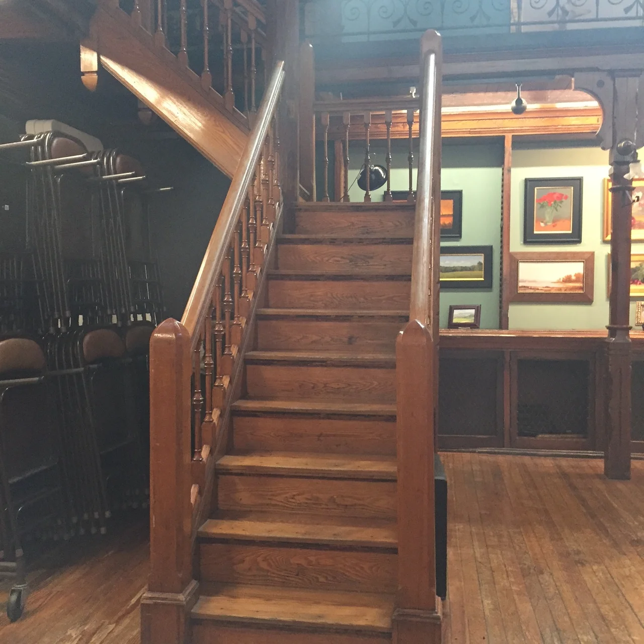 Up these stairs and around the top narrow balcony, you'll find the volumes of newspapers...