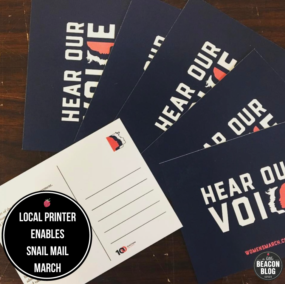 Grey Printing, based in Cold Spring, used the pre-designed postcard art provided by Women's March on Washington to print stacks of postcards for locals to order. Photo Credit: Grey Printing