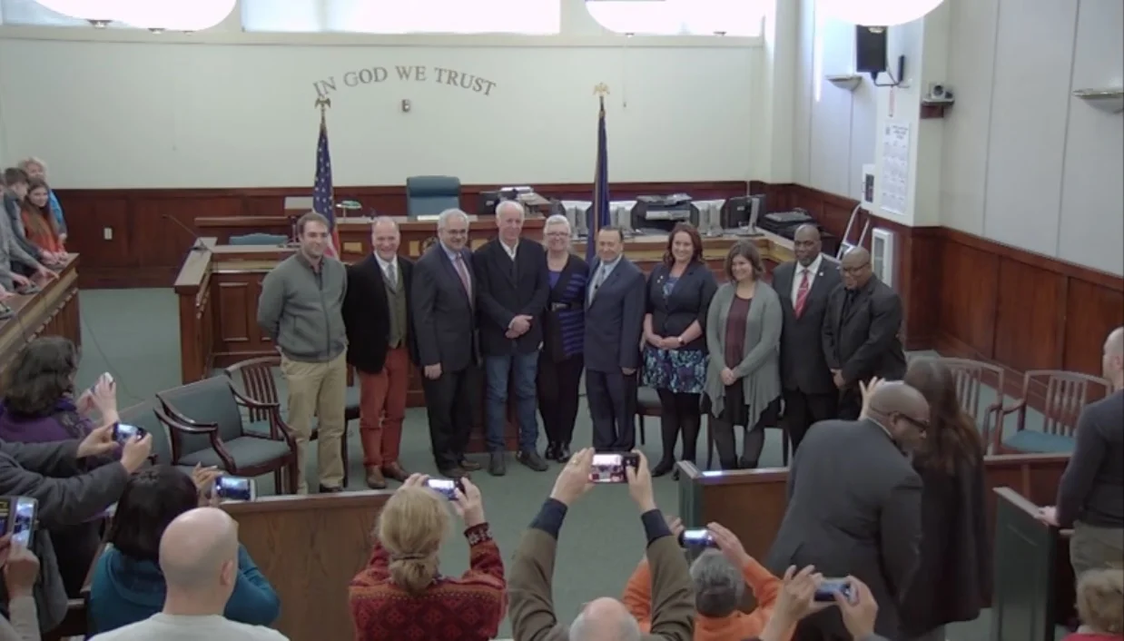 The local paparazzi (aka friends and families showing support). Photo Credit: Screenshot of Swearing In Ceremony from video produced by Peter Skorewicz.