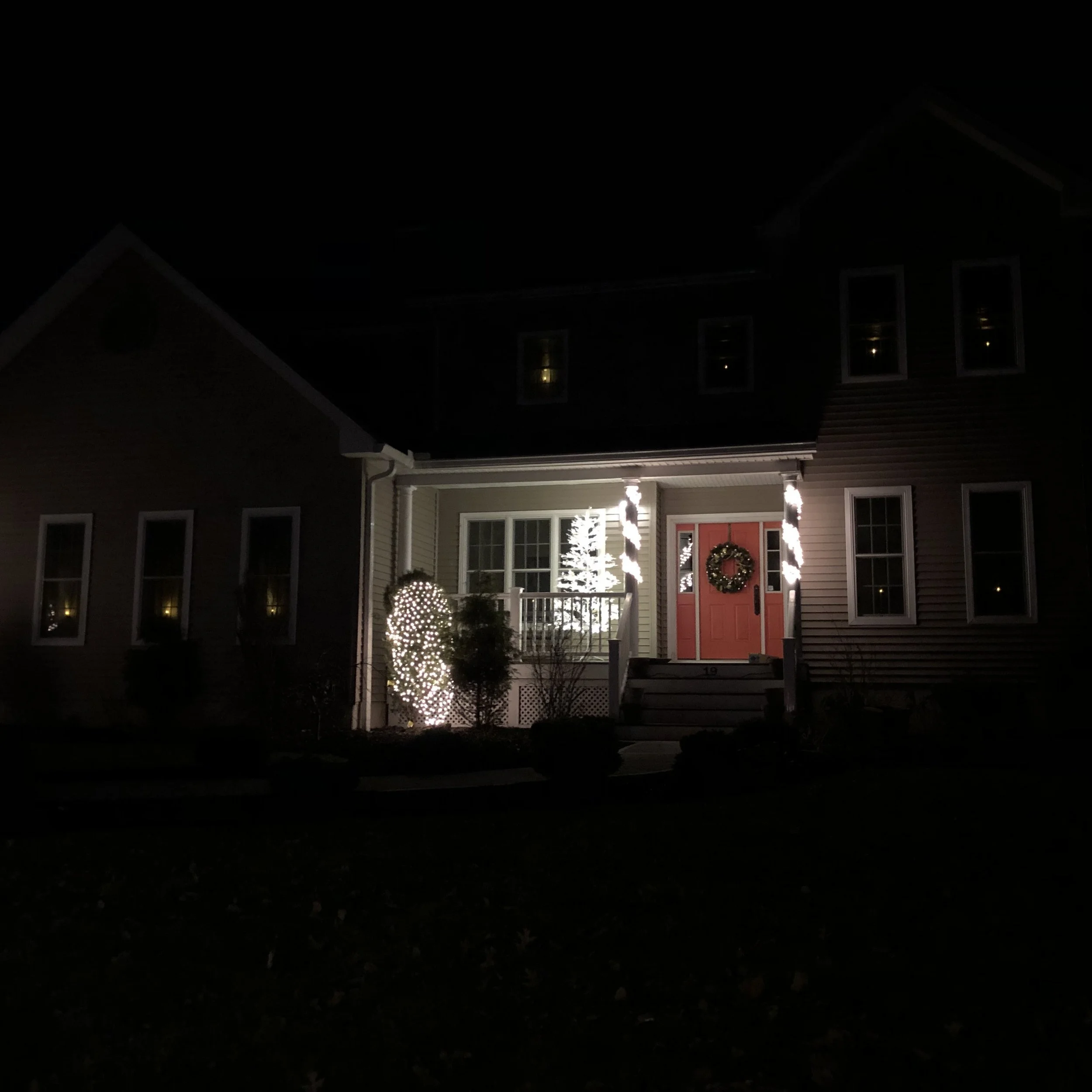 Brightly lit trees on front porches emerged as a theme early on. In order to capture these white lights on the tree, we had to sacrifice the rest of the house in the dark. #iphonechallenged