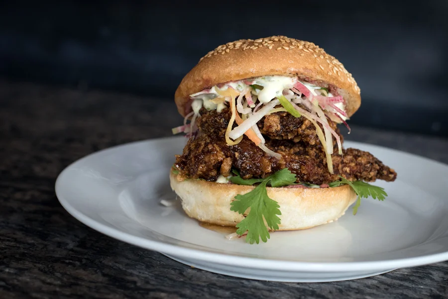 The Brooklyn Warehouse : Fried Chicken Bahn Mi with daikon slaw, cilantro lime aioli, pate and five spice honey glaze.