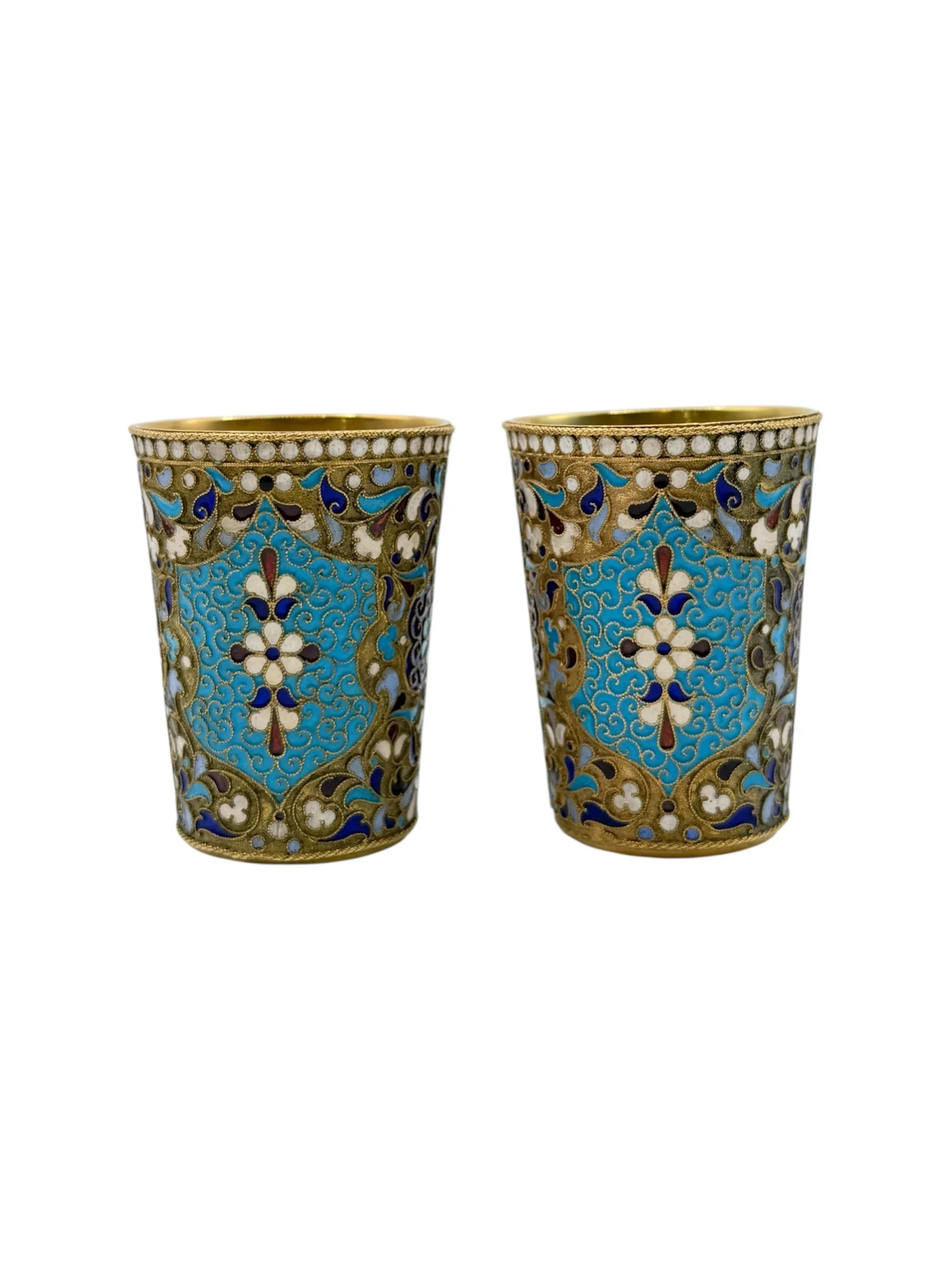 Russian silver gilt and cloisonné enamel pair of vodka cups, Moscow c.1900 by Dmitriy Nikolaev.