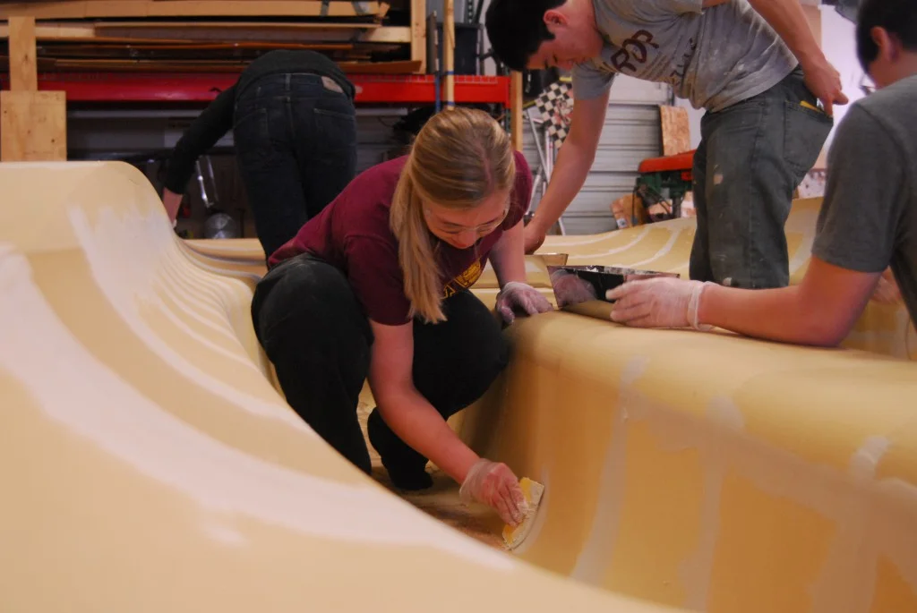 Aero team lead Hannah Mertens leads the effort to finish the mold.