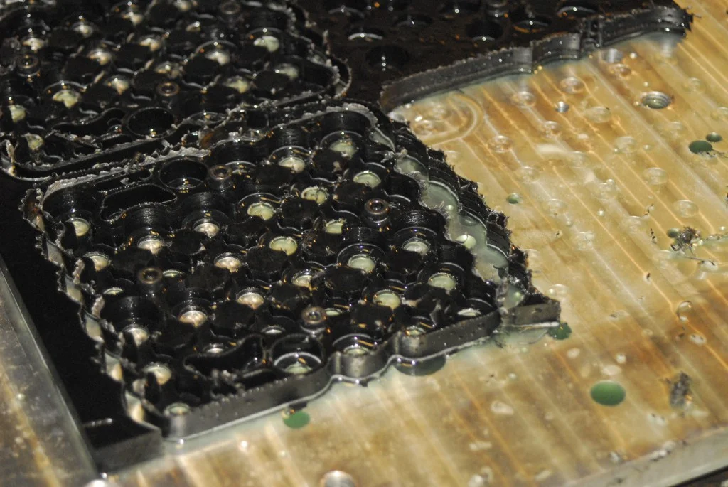 Battery brackets on the CNC bed. They are held down with 4 bolts each.