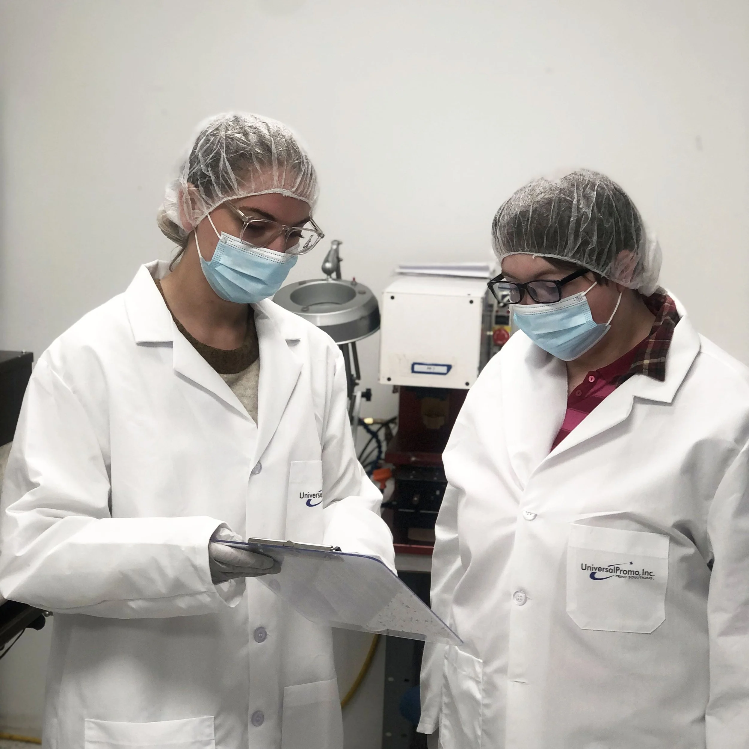 two women looking over a clip board