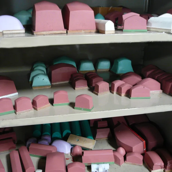 shelves filled with pad printing pads in various shapes and sizes