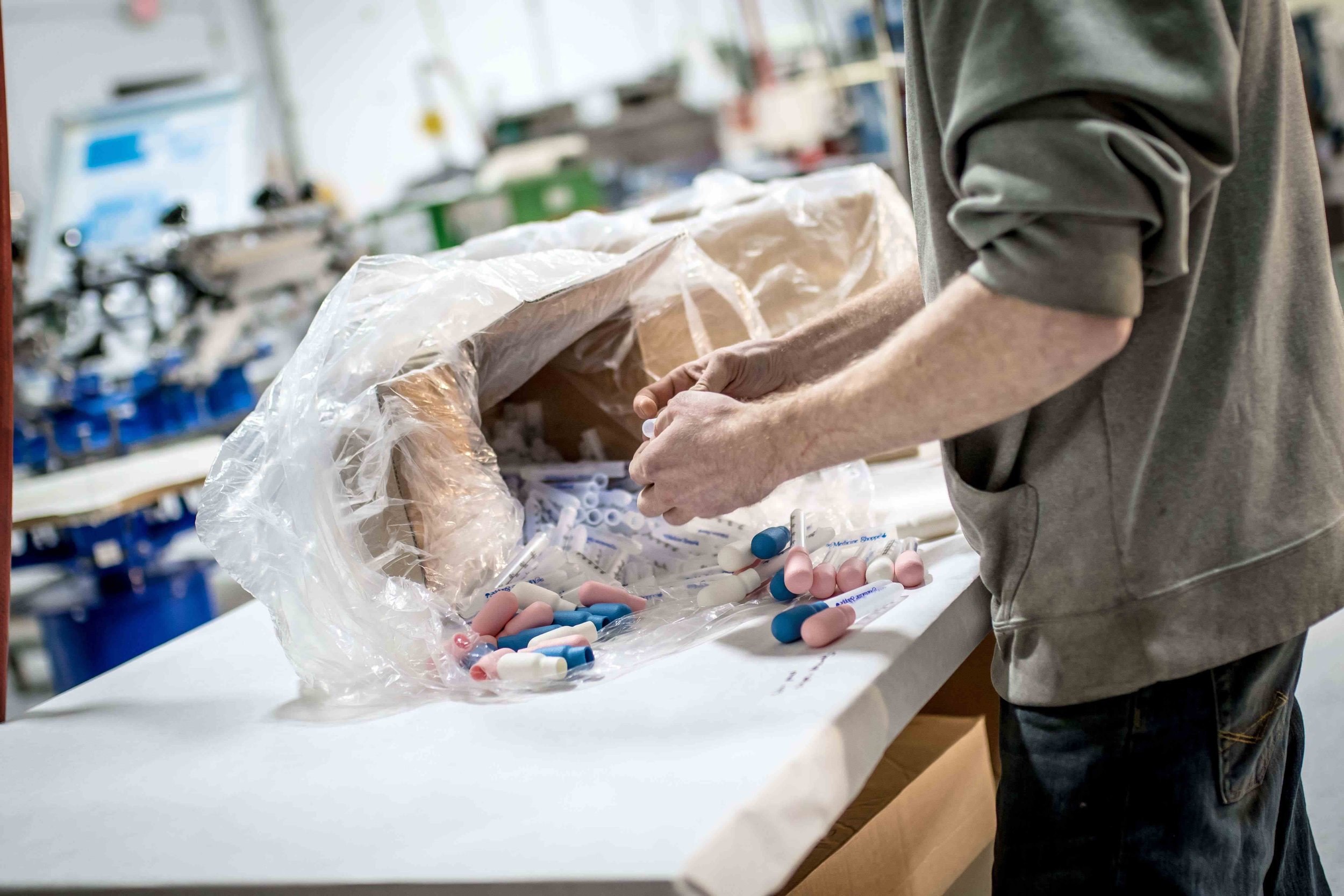 close up of a man assembling droppers