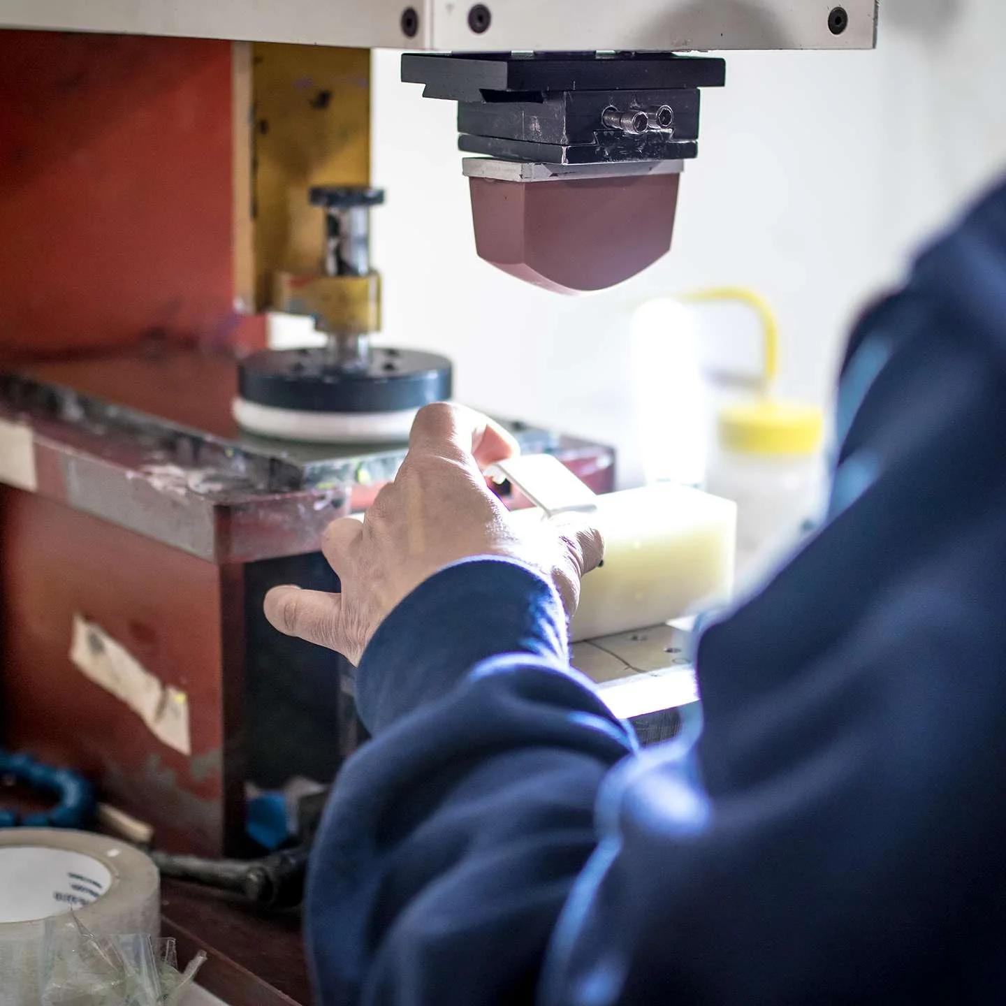 close up of a woman pad printing small medical housing unit