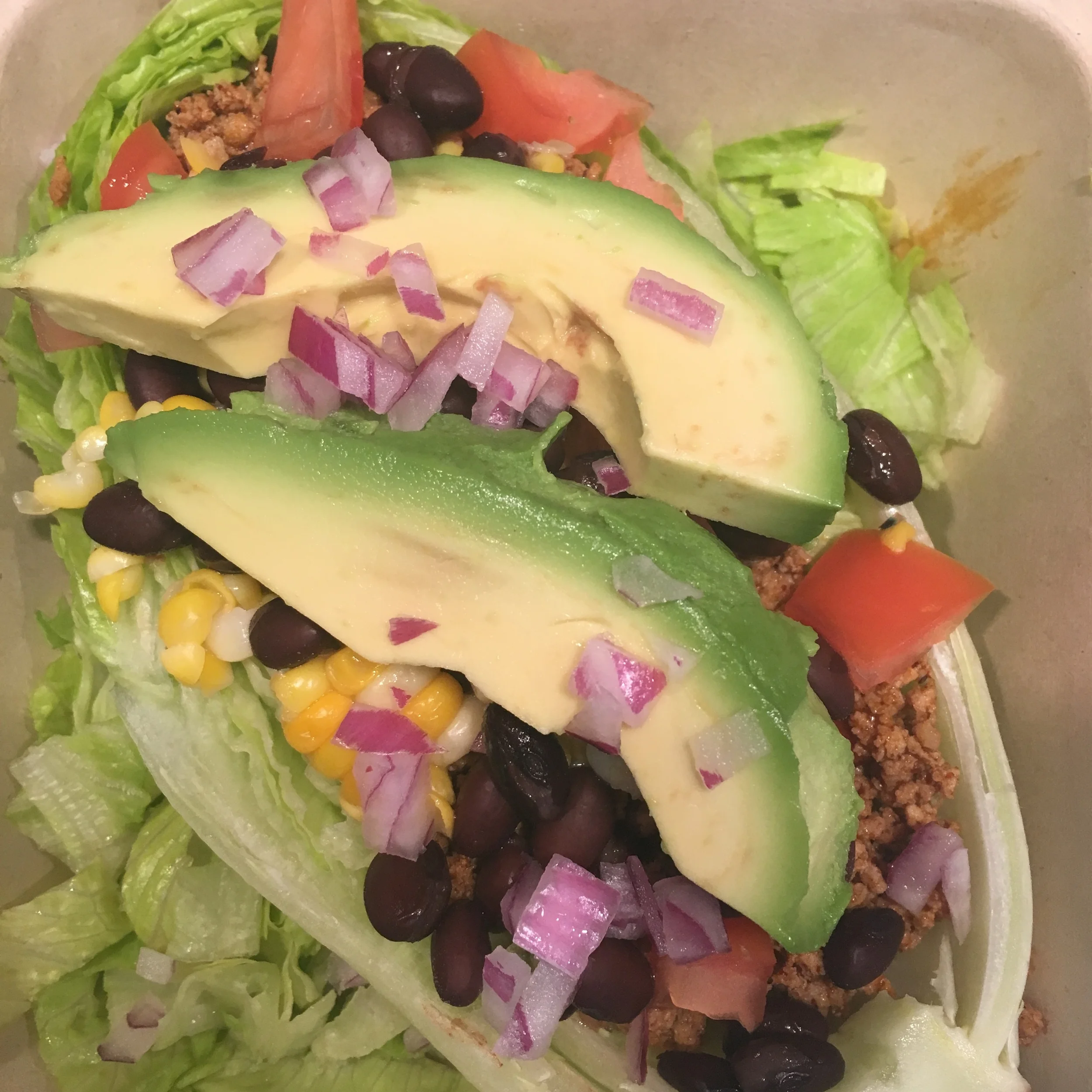 Turkey Taco Salad over Romaine Heart, Avacado, Black Bean, Corn, Tomato and Red Onion