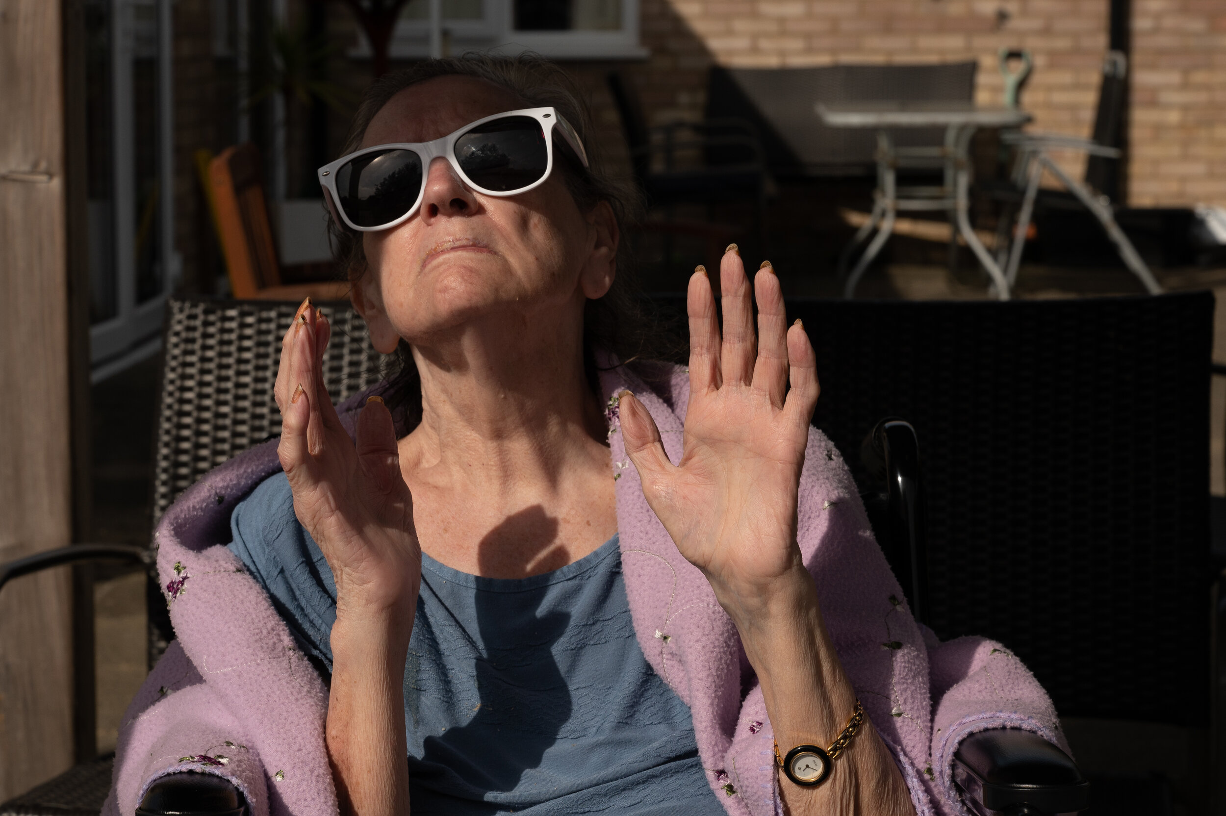  A brief respite between lockdowns brings a chance for Janice to sit outside and enjoy a moment in the sunshine. This was the first time in seven months that her or any of the other residents would have smelled the fresh air or seen the sky with thei