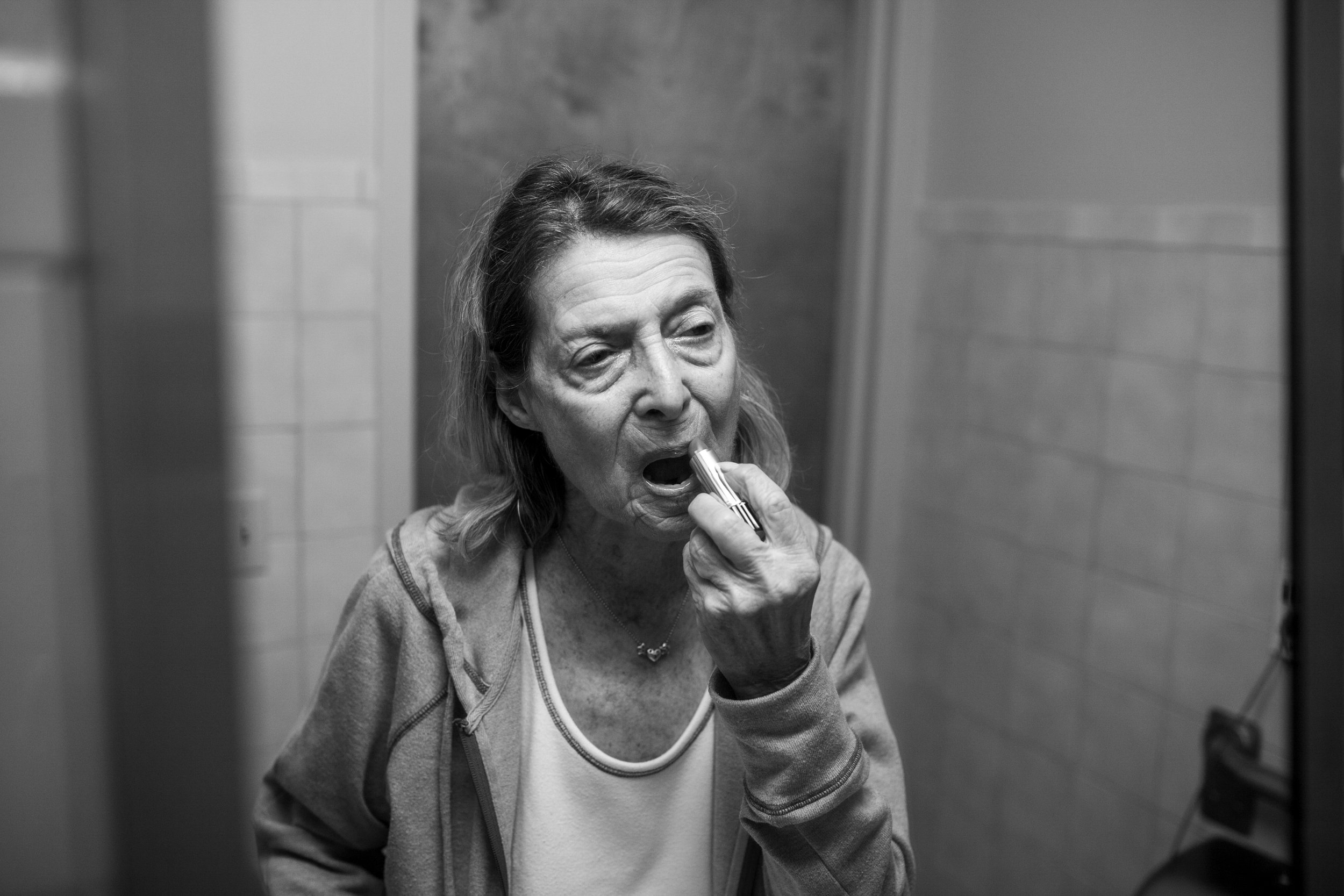  After her hospital stay in 2017, Audrey entered a rehabilitation facility. Here she is putting on her lipstick, thinking she was going to leave with me. She became angry when she found out otherwise. March 2017 