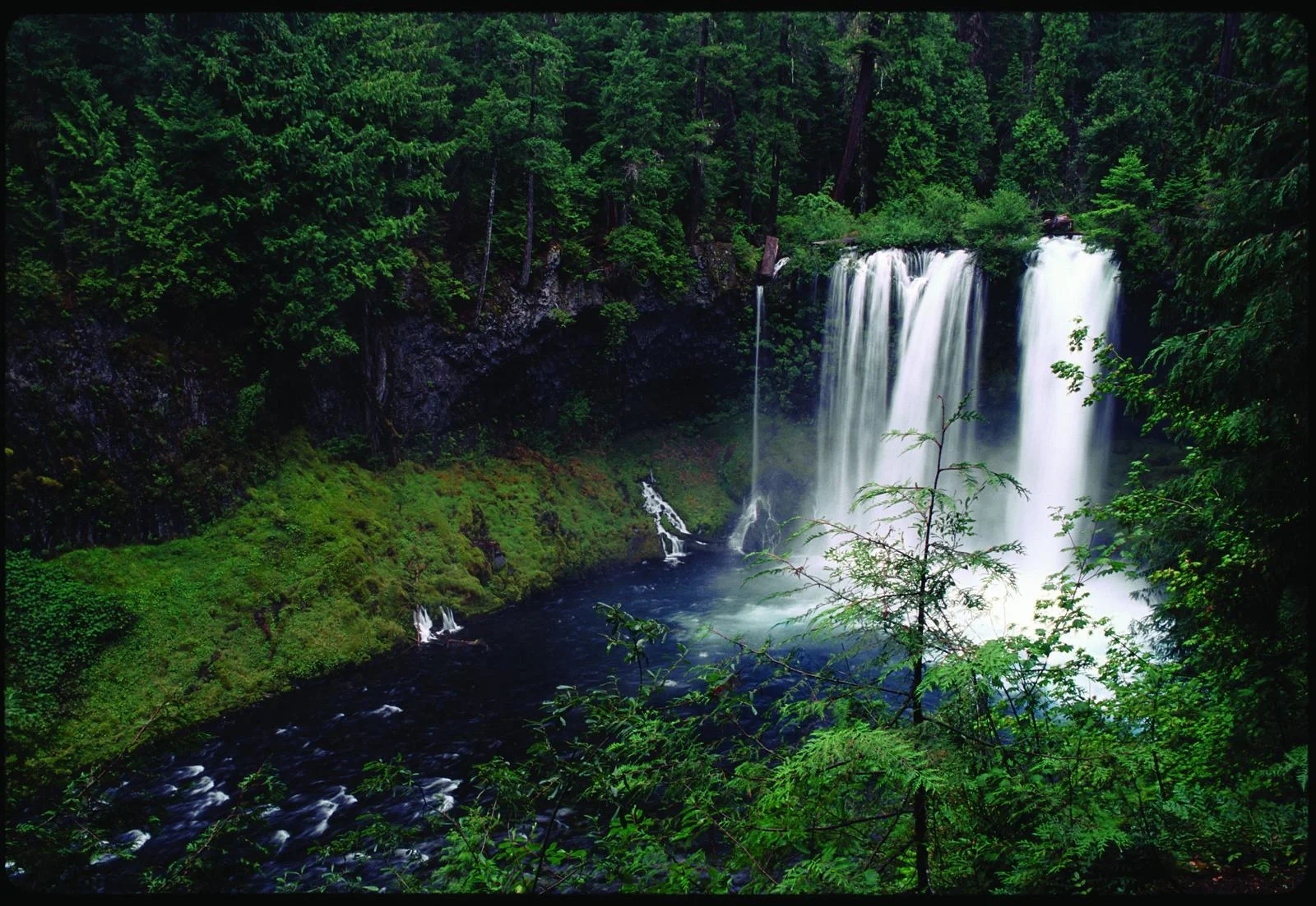 Figure 1. Koosah Falls on the McKenzie River. The segment between Clear Lake and Carmen Reservoir is included in both the National Wild and Scenic Rivers System and the Oregon Scenic Waterways System. Source: George Wuerthner (first appeared in Oregon Wild: Endangered Forest Wilderness ).