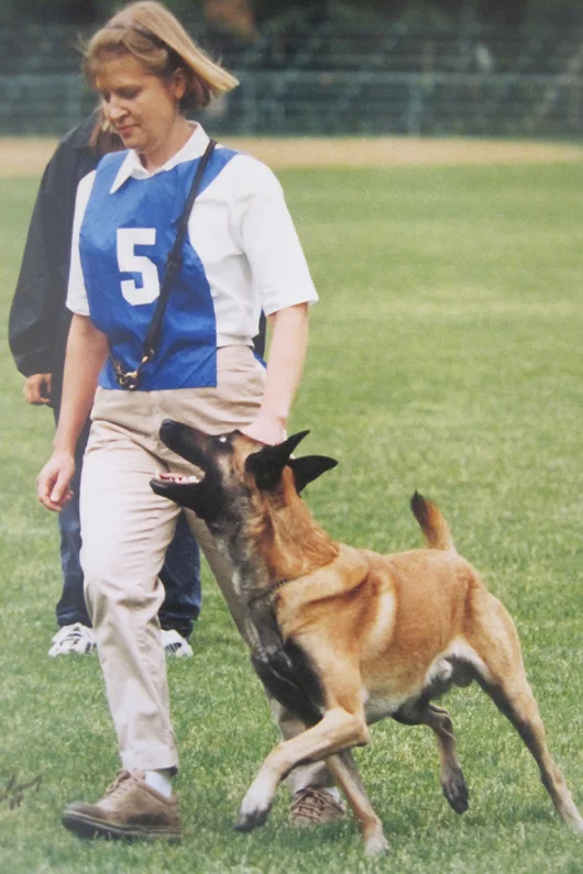 With my "heart dog" Cory Ot Vitosha SchIII, IPO III. Here we are competing in Schutzhund nationals, 1999.