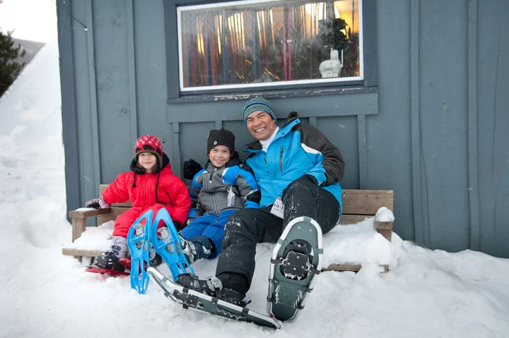 Snowshoeing Dad with kids at Smuggler's Notch Resort