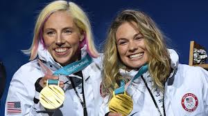 Kikkan Randall and Jessie Diggins show their gold