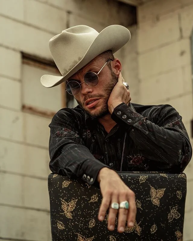 Thank y’all for listening to “Welcome To Hard Times”. I wrote this song back in November along with most of the other numbers on the album. I didn’t know then what was waiting for America in 2020. 40 million unemployed as of this week. Uncertainty over our future due to a mysterious virus that’s everywhere and nowhere at the same time. Unarmed black men being killed in the streets by white authorities and vigilantes alike all caught on an iPhone. The poor white seems to be growing endlessly poorer while we see dizzying amounts of money flowing to the ivory towers of our society to alleviate their troubles. This is why our generation lives in such deep discontent. A politician accepts money from the rich and votes from the poor promising to protect them from one another. We have no voice in the halls of power. The older generations are quick to exercise their rights and are the loudest voices when they want to communicate their needs. We are the largest generation in American history and it’s our burden to face the coming decades, and the implications are severe to put it lightly. They label us as lazy, but we didn’t send America’s jobs overseas never to return again due to rapidly evolving technology. Too many are silent when the oppressed are murdered in the streets, but quick to defend the idea of property and side with authority. I considered taking my first single down due to the unprecedented circumstances in America this week but then I thought about my own life and the circumstances that forced me onto my path as an outsider. Though I’ve benefited greatly from my light skin tone I have never fully identified with any race. So I’ve lived as an outcast at war with myself in a society that I both love and hate at the same time. My music tells this story. If you don’t know how race or class affects experience, it’s the first sign of privilege. We’re all fighting great battles. I see it in the eyes of Americans everyday. But some folks just have it harder. The times are changing and I stand with the poor and the down trodden. I stand with the honest voices of my generation. If that ain’t country enough, y’all can have it. 
photo @_benchristensen