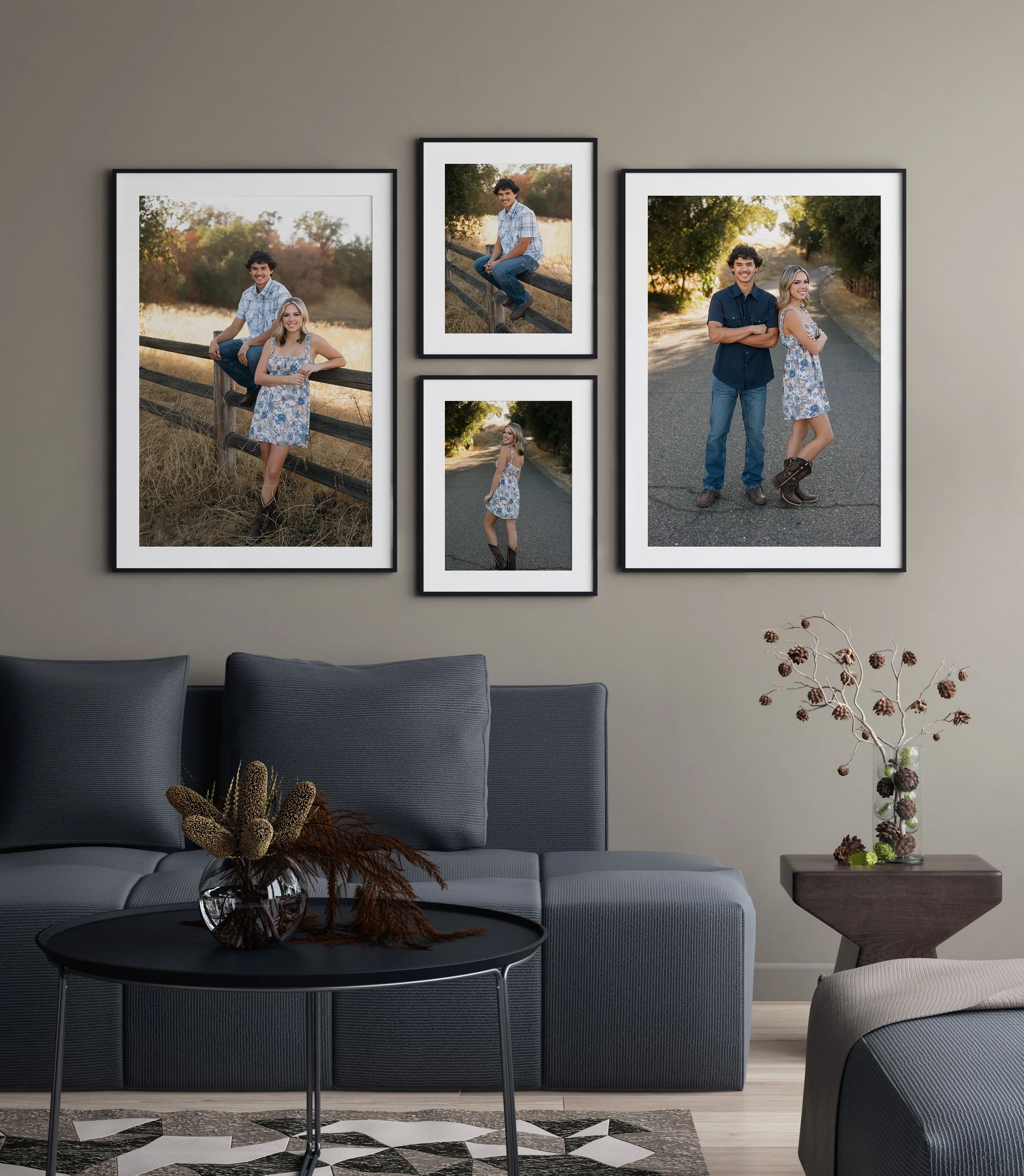 Living room with gray sofa, coffee table with vase of flowers, and wall decor featuring framed outdoor photos of a young man and woman, and a young man alone.