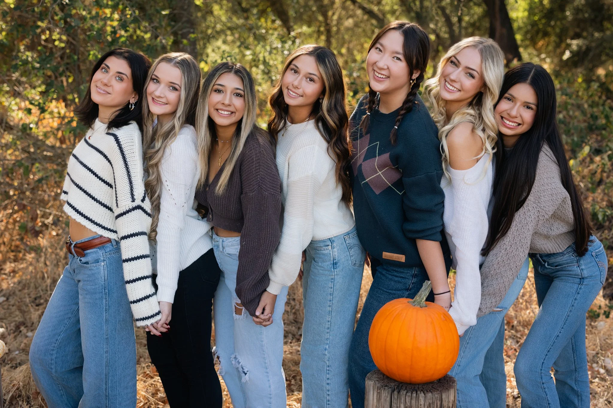 Mc Senior Model Team posing with pumpkins during their fall photoshoot