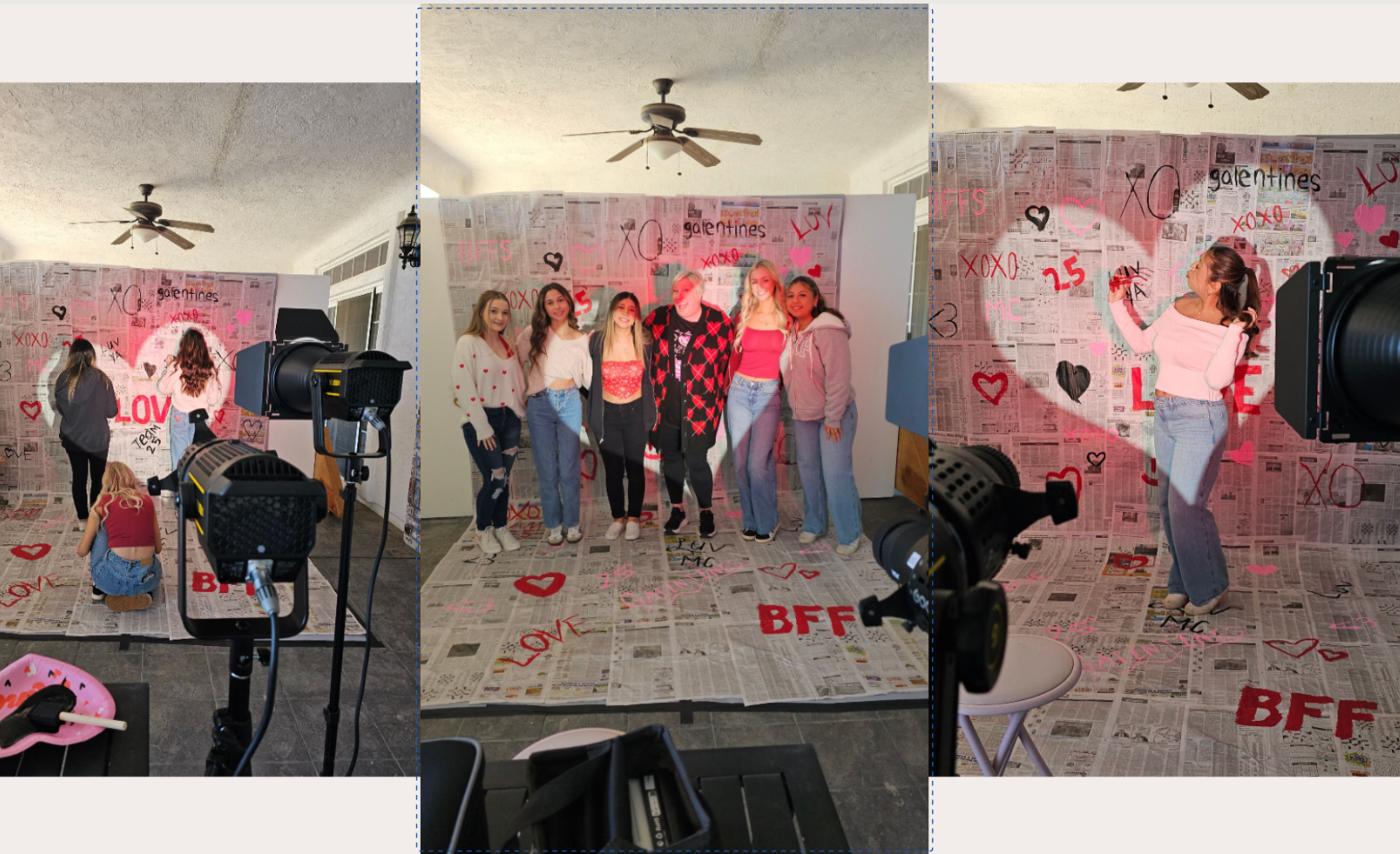 A group of young women and a person in a birthday party setting with a newspaper-themed backdrop decorated with pink and black hearts, words like "LOVE," "XOXO," and "BFF," and a red "25". Several cameras are set up in front of the backdrop, and a woman is posing for photos on the right side.