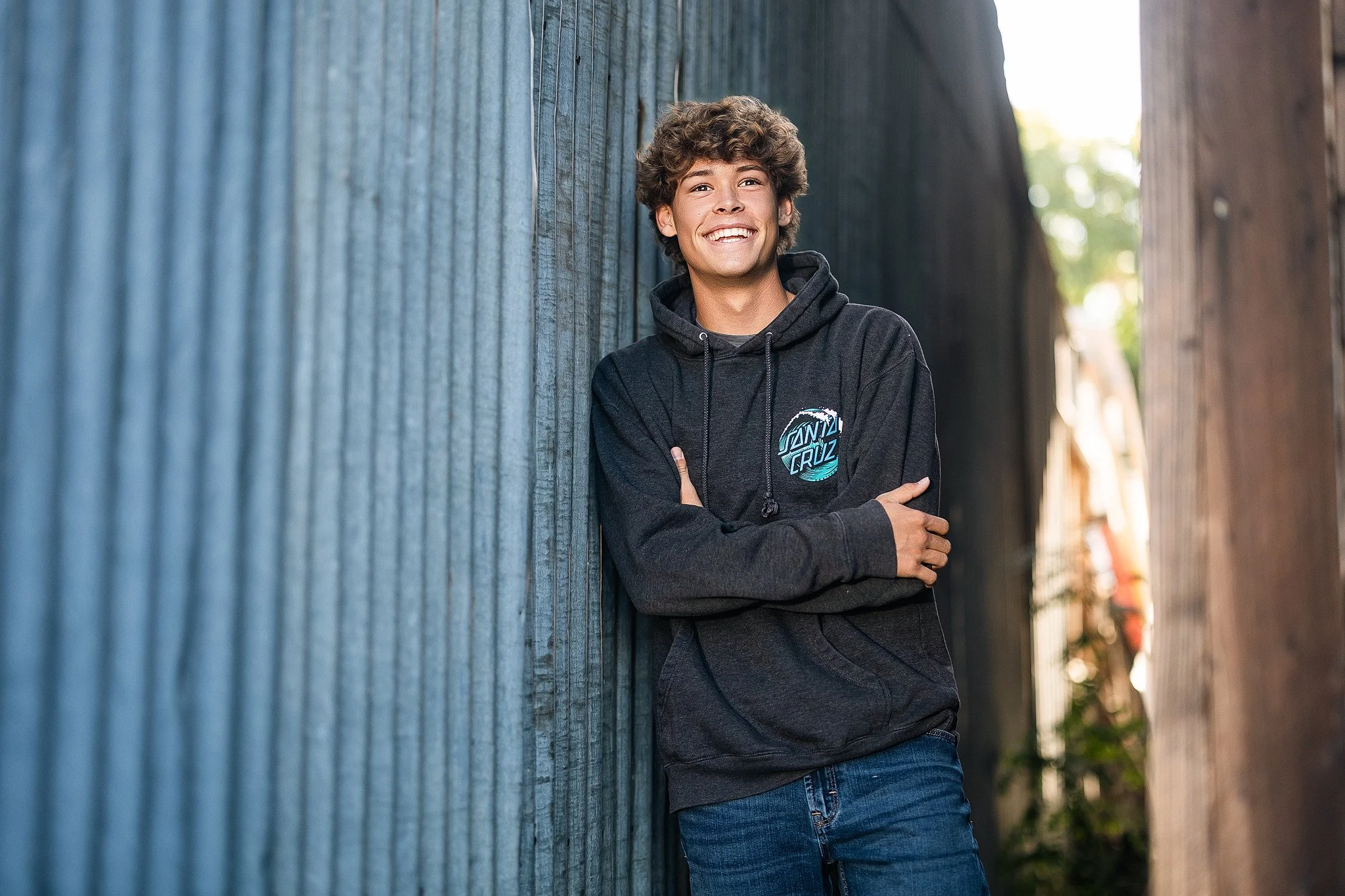 Folsom High School senior guy posing for black and white senior pictures in Historic Old Town Folsom, California.